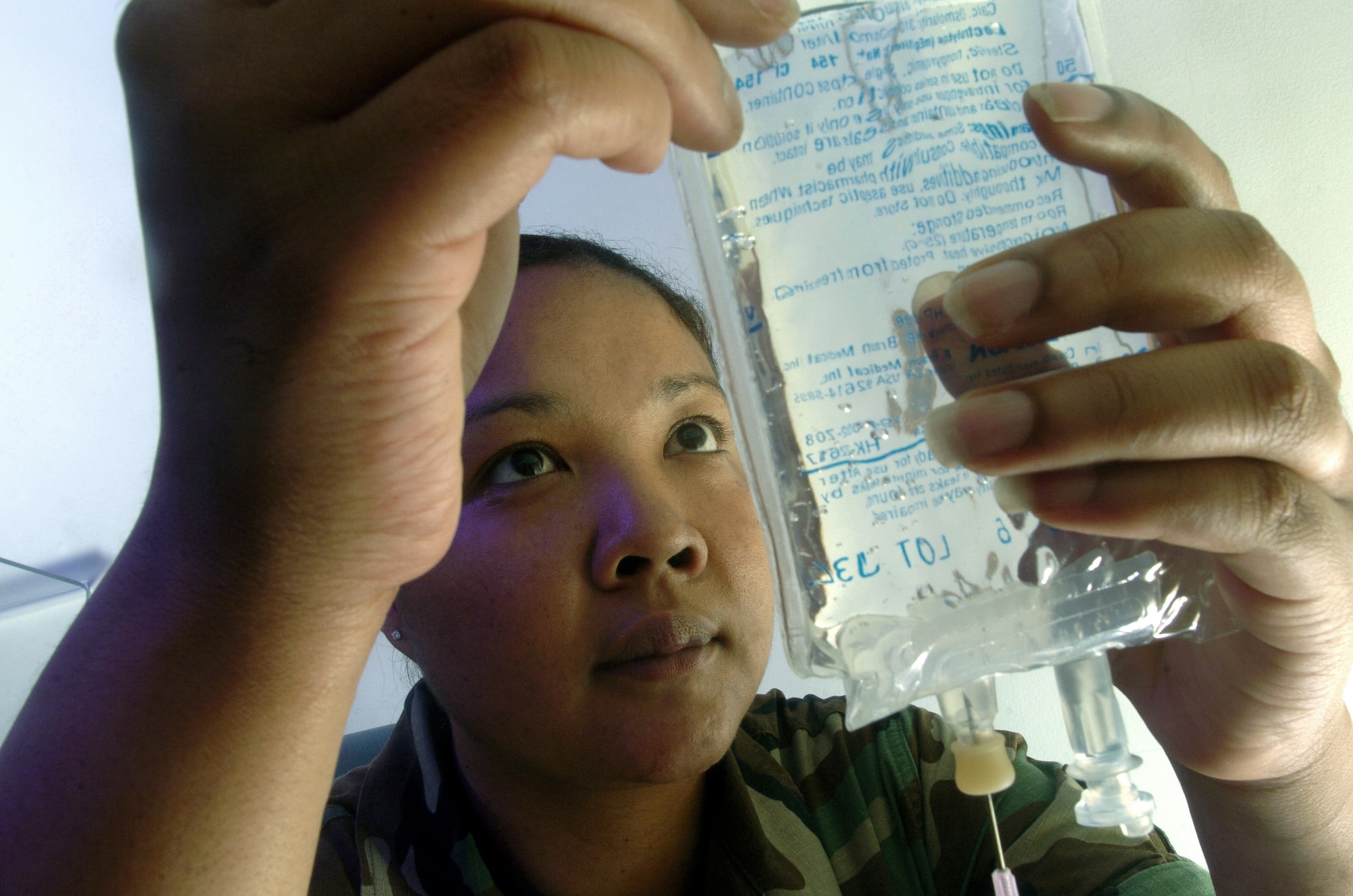 YOKOTA AIR BASE, Japan -- Tech. Sgt. Adrian Crumrine prepares an IV bag at the hospital here.  She is a pharmacy technician assigned to the base's 374th Medical Group.  The pharmacy staff handled more than 84,000 prescriptions last year.  (U.S. Air Force photo by Master Sgt. Val Gempis)