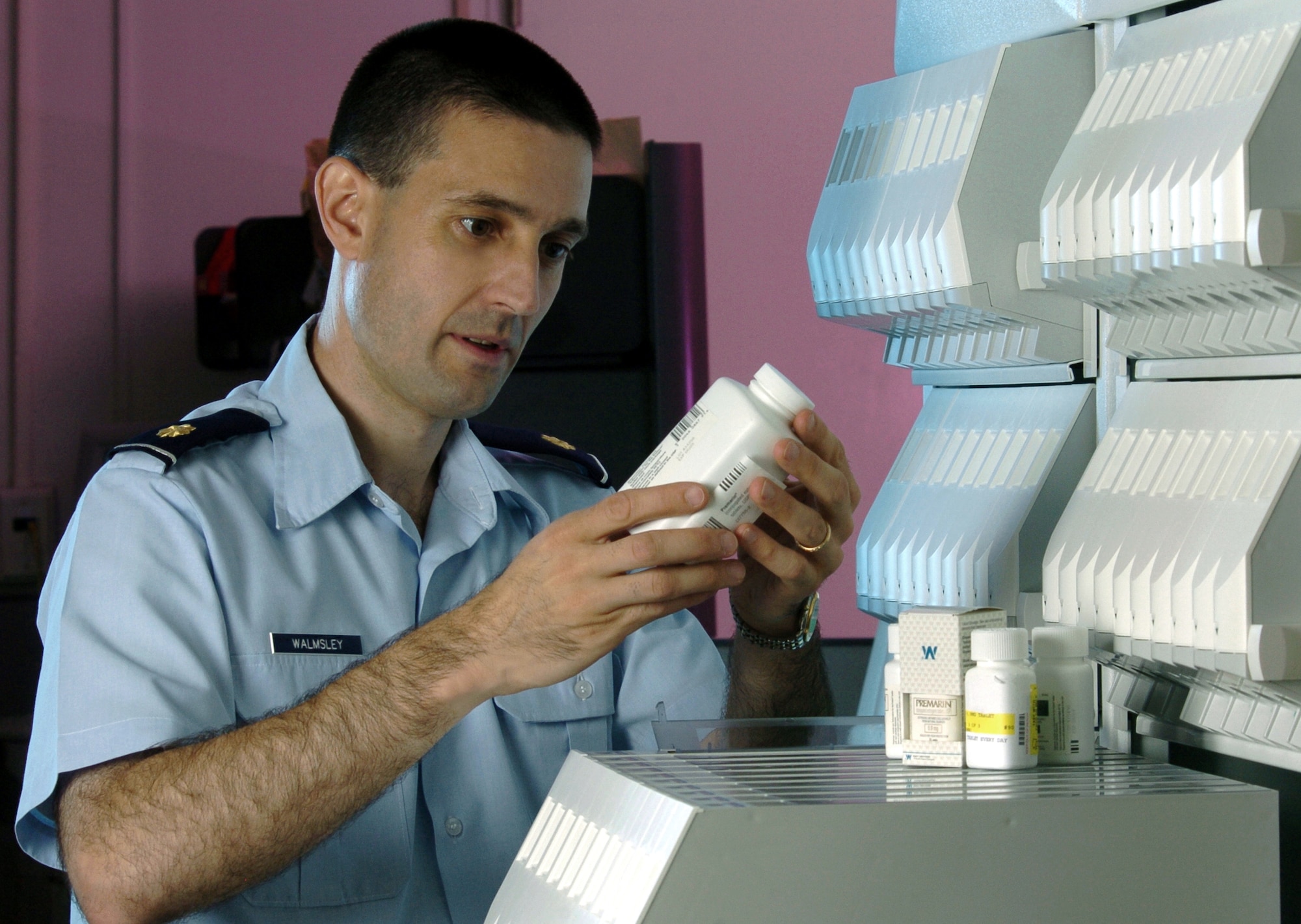 YOKOTA AIR BASE, Japan -- Maj. David Walmsley checks the expiration date on a medicine container at the hospital here.  He is a pharmacist for the base's 374th Medical Group.  The pharmacy staff handled more than 84,000 prescriptions last year.  (U.S. Air Force photo by Master Sgt. Val Gempis)