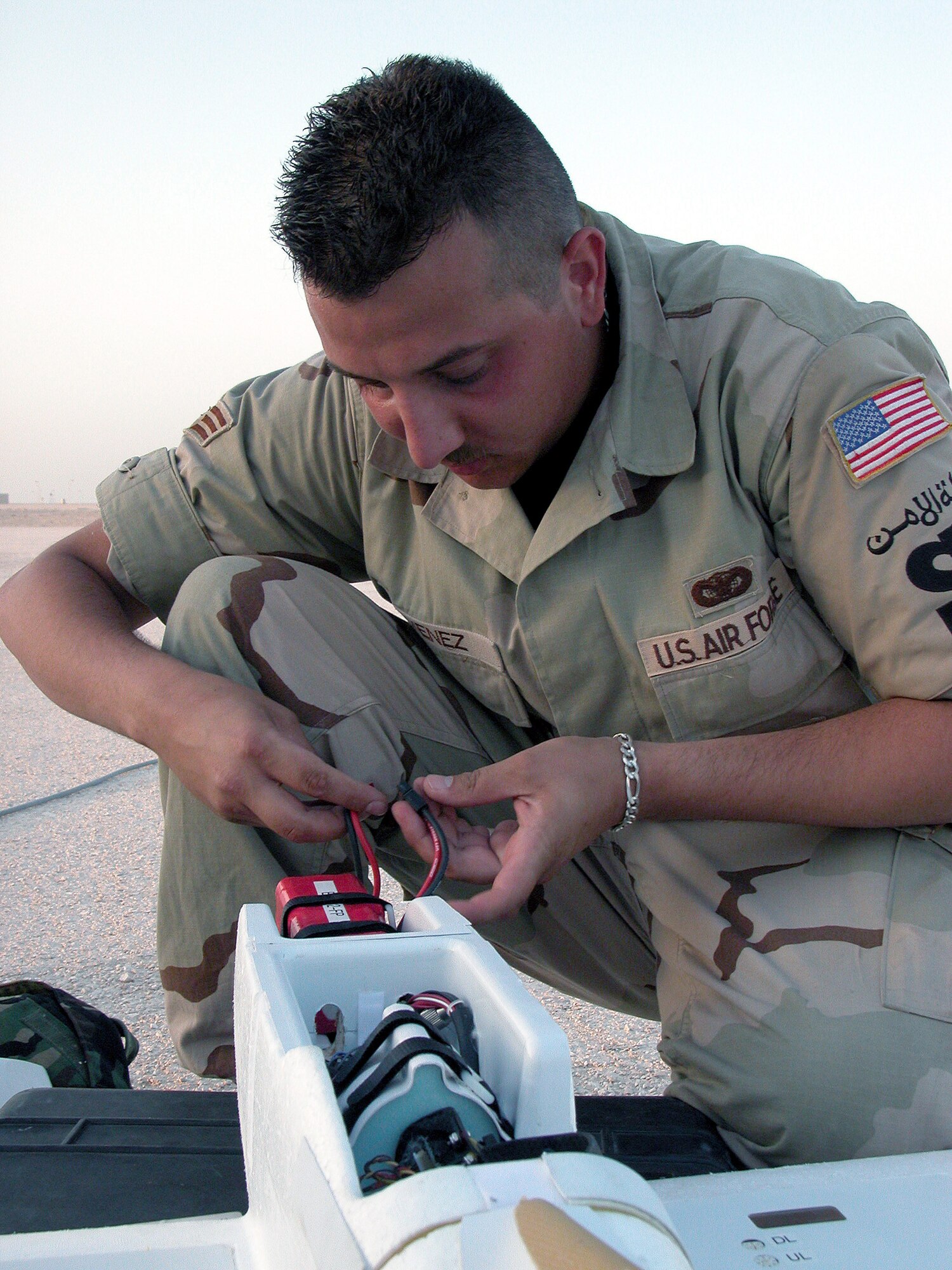 SOUTHWEST ASIA -- Senior Airman Alexander Jimenez changes the battery in a Desert Hawk unmanned aerial vehicle.  He is assigned to the 379th Security Forces Squadron's airborne surveillance program and is deployed from Spangdahlem Air Base, Germany.  (U.S. Air Force photo by Staff Sgt. C. Todd Lopez)  