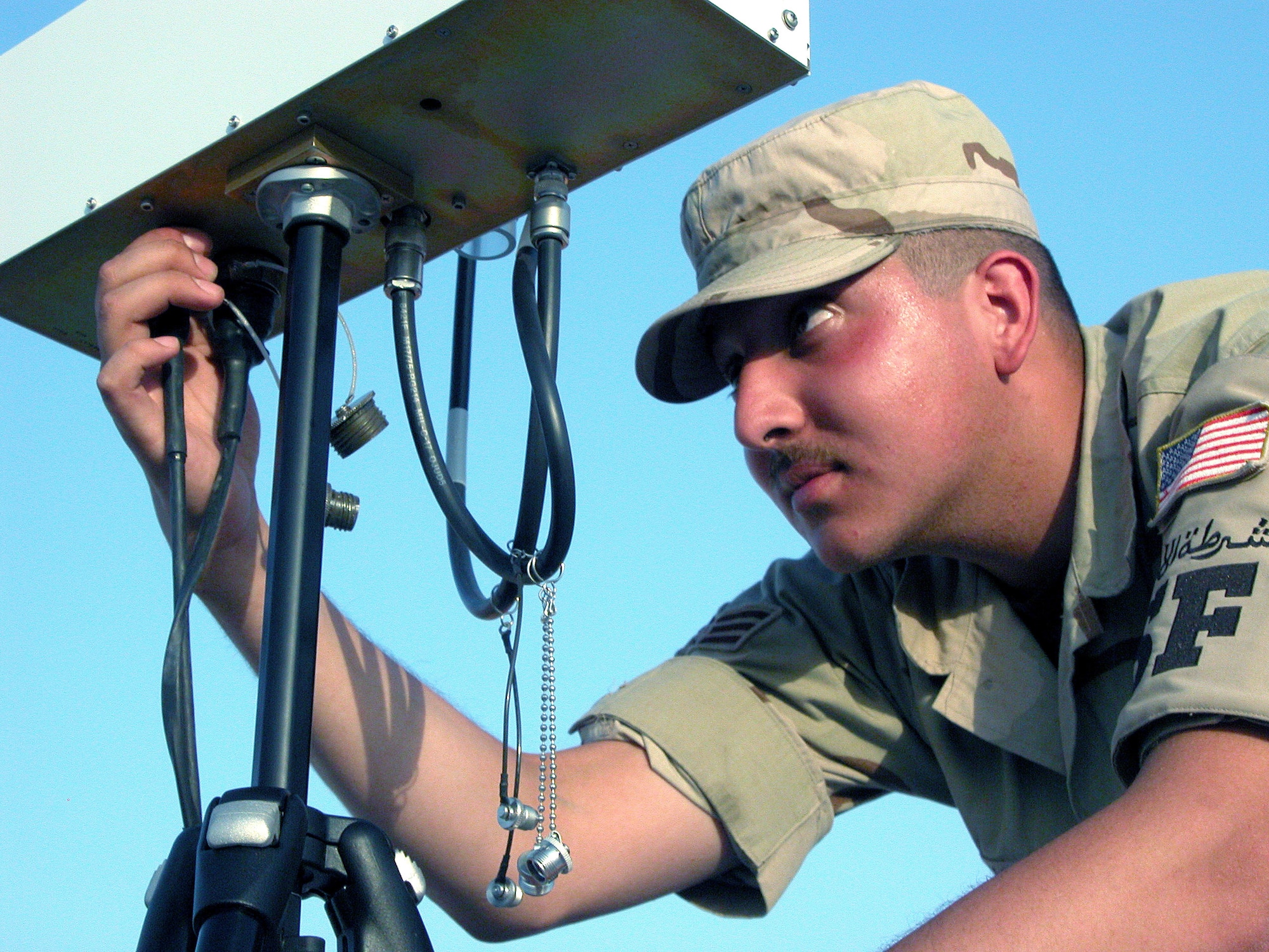 SOUTHWEST ASIA -- Senior Airman Alexander Jimenez makes adjustments to the antenna that controls the Desert Hawk unmanned aerial vehicle.  He is assigned to the 379th Security Forces Squadron's airborne surveillance program and is deployed from Spangdahlem Air Base, Germany.  (U.S. Air Force photo by Staff Sgt. C. Todd Lopez)  