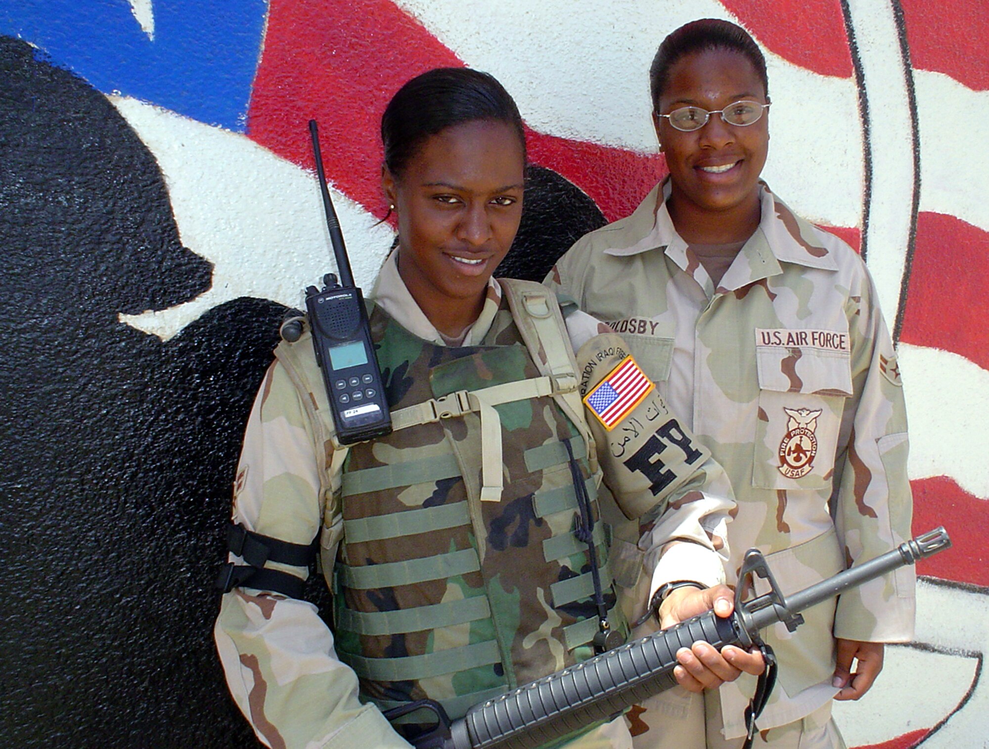 TALLIL AIR BASE, Iraq -- Airmen 1st Class Shawn Brown (left) and Lattrice Goldsby are sisters and deployed here from Kadena Air Base, Japan.  Except for technical schools, the sisters have been together throughout their military careers.  They are two of a set of quadruplets.  (U.S. Air Force photo by Master Sgt. Debbie Aragon)