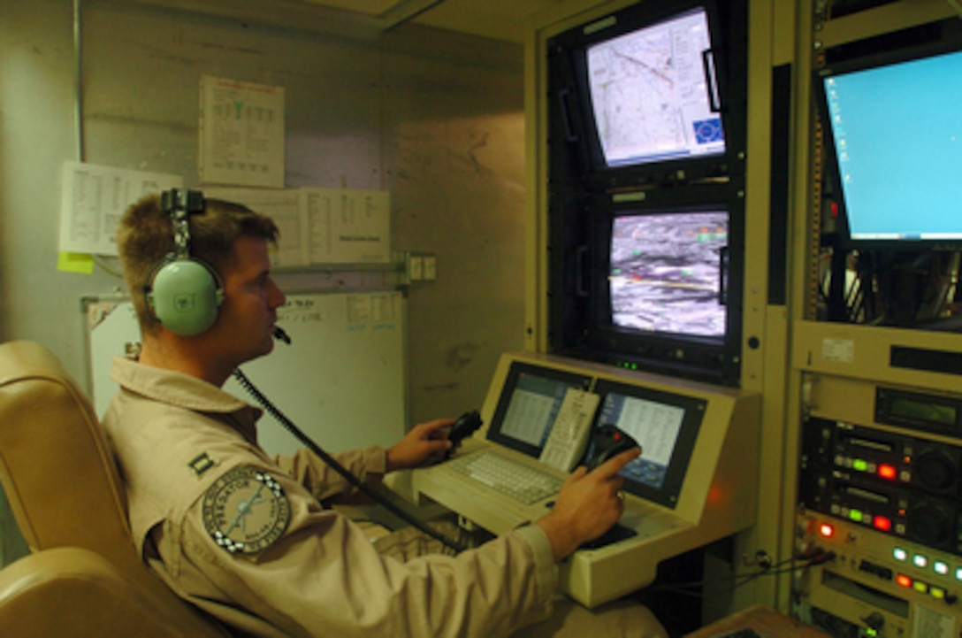 Air Force Captain John Songer maneuvers an unmanned Predator reconnaissance airplane over Iraq by remote control at Balad Air Base, Iraq, on July 2, 2004. The Predator is an unmanned airplane that provides live aerial imagery of Iraq. Songer is deployed from the 15th Reconnaissance Squadron at Nellis Air Force Base, Nev., in support of Operation Iraqi Freedom. 