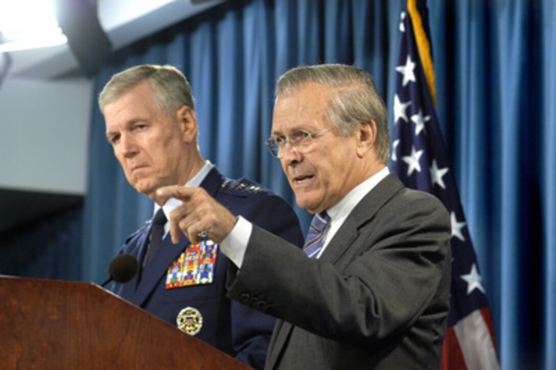 Secretary of Defense Donald H. Rumsfeld calls on a reporter for a question during an operational update press conference in the Pentagon on July 21, 2004. Joining Rumsfeld at the lectern is Chairman of the Joint Chiefs of Staff Gen. Richard B. Myers, U.S. Air Force. 