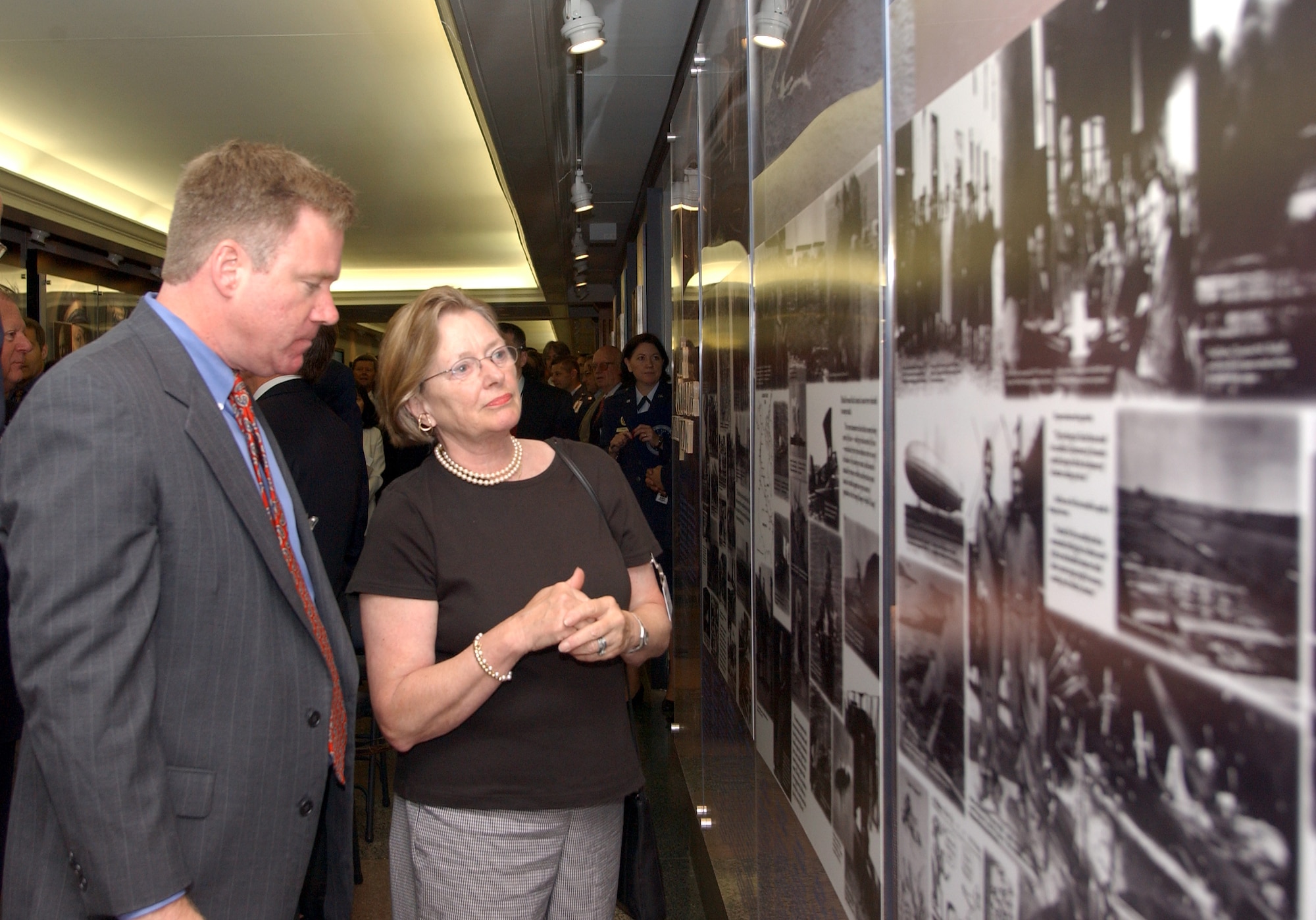 WASHINGTON -- Cicely Banfield, granddaughter of Brig. Gen. William "Billy" Mitchell, and her son, Landon Banfield, view the new founding fathers of the Air Force exhibit July 21 in the Pentagon.  The exhibit was opened 83 years after General Mitchell's bombers sank the captured German battleship "Ostfriesland," testing the usefulness of planes in combat versus ships.  (Courtesy photo)