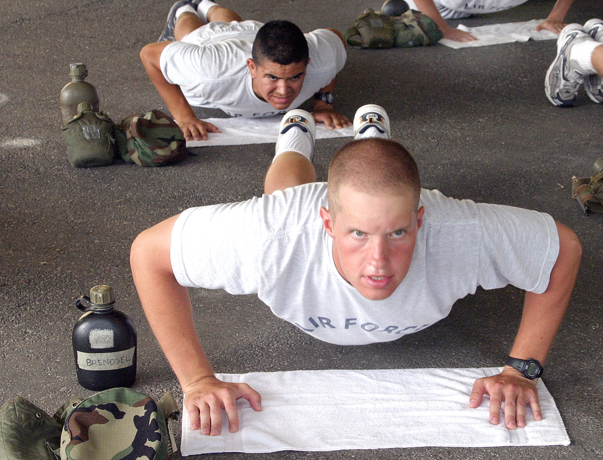 LACKLAND AIR FORCE BASE, Texas -- Cadet Eric Brendsel (foreground) does push-ups during afternoon physical training for ROTC cadets here.  More than 500 cadets completed six weeks of ROTC field training here July 23.  Cadet Brendsel is a student at the University of Iowa.  (U.S. Air Force photo by Robbin Creswell)