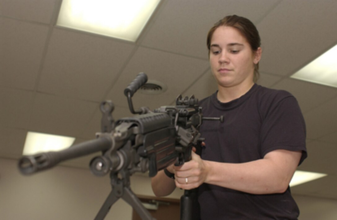 Air National Guardsman 1st Class Melissa Knight disassembles a M-249 Squad Automatic Weapon during annual training in Savannah, Ga., on July 15, 2004. Knight is assigned to the Security Forces from the 130th Airlift Wing, West Virginia Air National Guard, Charleston, W. Va. 