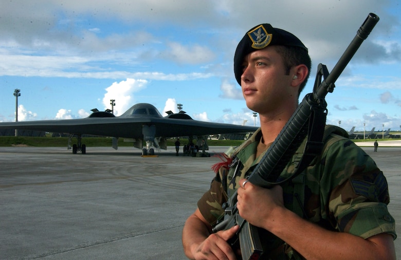 ANDERSEN AIR FORCE BASE, Guam (AFPN) -- Senior Airman John Key guards an entry-control point near a B-2 Spirit bomber recently during a Coronet Bugle 49 exercise here.  Airman Key is assigned to the 509th Security Forces Squadron at Whiteman Air Force Base, Mo. He is deployed supporting B-2 operations as part of Air Combat Command's ongoing global power missions. The missions enable aircrews to train for long flights from the United States to overseas locations. (U.S. Air Force photo by Staff Sgt. Tia Schroeder)