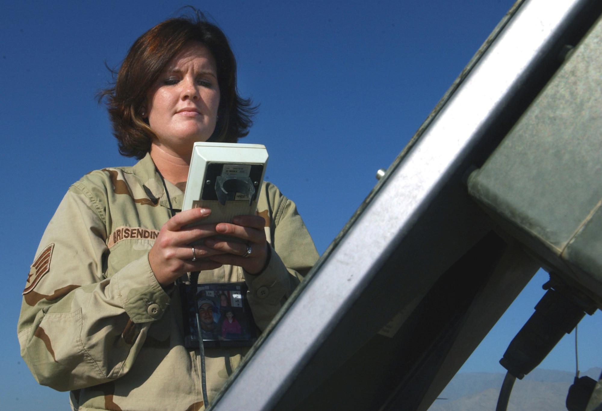 BAGRAM AIR BASE, Afghanistan -- Staff Sgt. Sherdean Brisendine adjusts the Tactical Meteorological Observation System, a portable system to help forecasters take barometric pressure, temperature, and wind direction and speed readings.  She is a 455th Expeditionary Operations Group forecaster here.  (U.S. Air Force photo by Master Sgt. Andrew Gates)