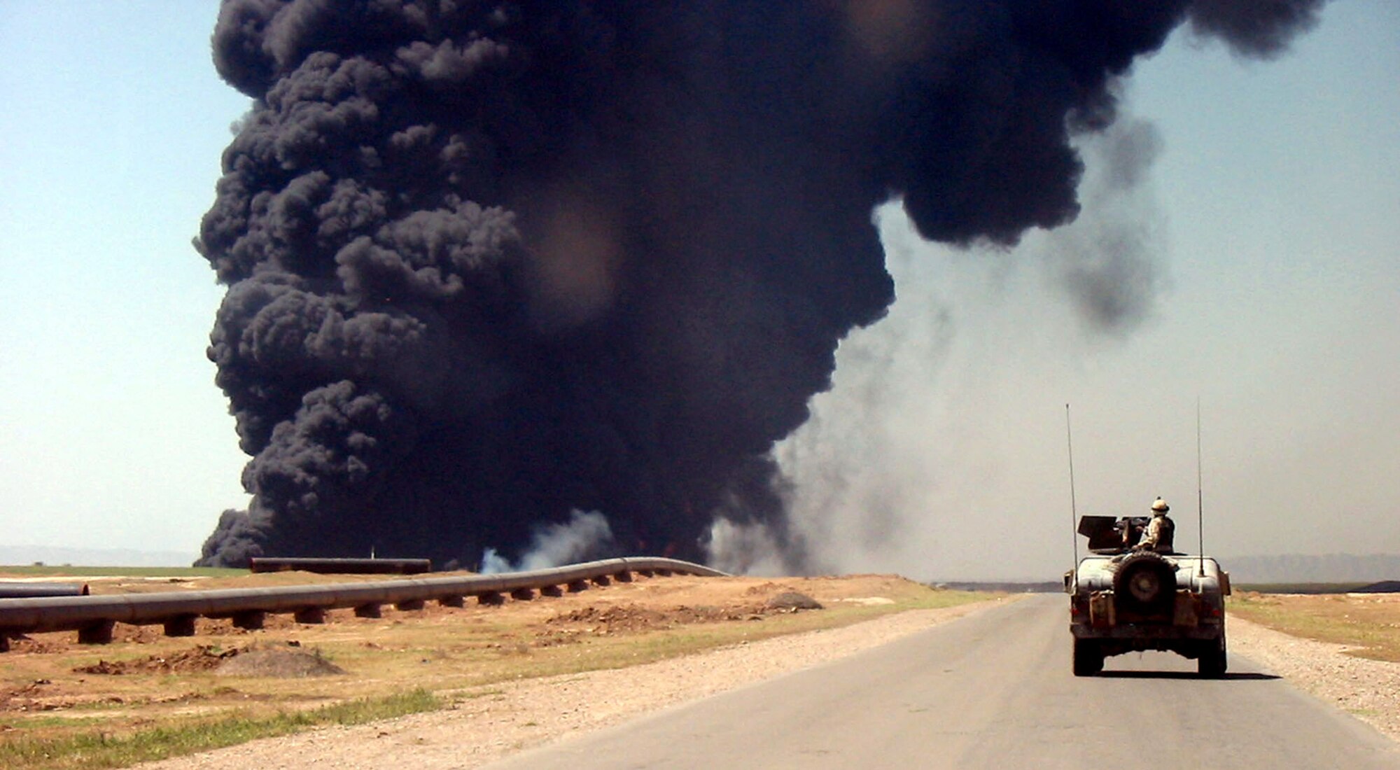 SOUTHWEST ASIA - A bomb explosion along a road is just one of the many hazards two explosive ordnance disposal technicians from Edwards Air Force Base, Calif., witnessed during a 90-day deployment.  (U.S. Air Force photo by Senior Airman Stephen Szczurek)