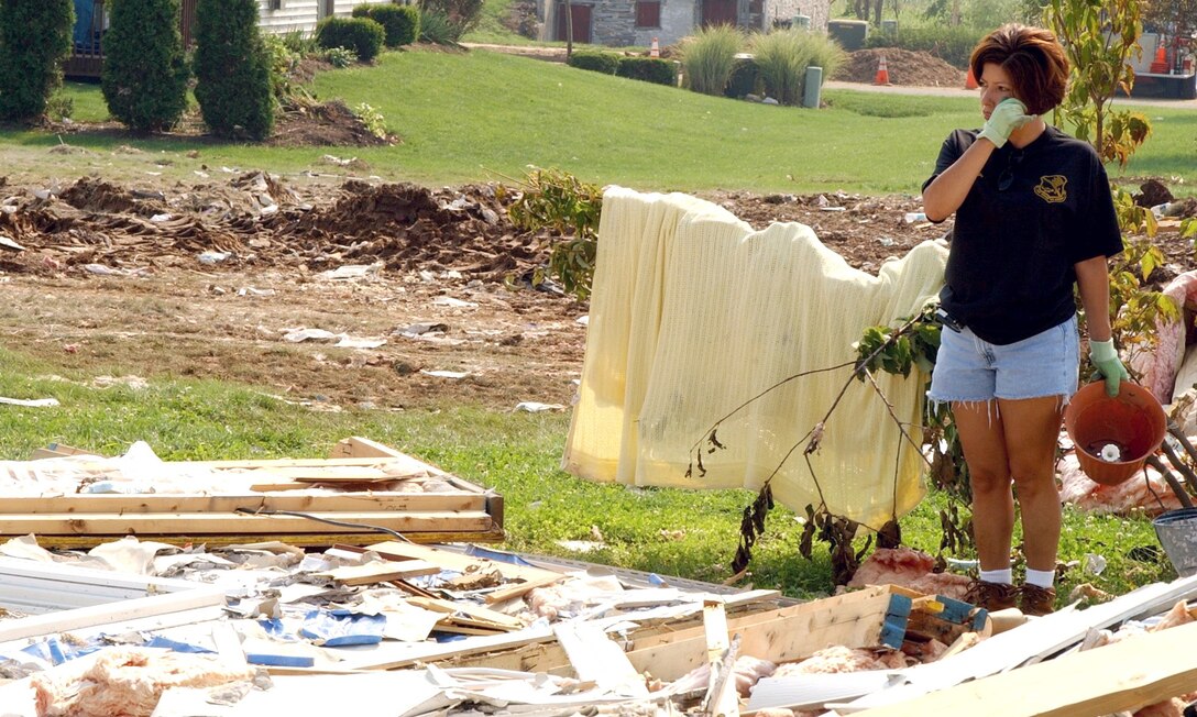 CAMPBELLTOWN, Pa. - Master Sergeant Regina Stotlzfus pauses to survey the devastation at what is left of a home belonging to Senior Master Sgt. John Stewart, an Air National Guardsmen with the 193rd Special Operations Wing at Middletown, Pa.  A tornado packing 200 mph winds destroyed the home July 14.  Sergeant Stotlzfus, the wing's first sergeant, joined other wing Airmen to help clean up.  (U.S. Air Force photo by Senior Airman Jay Ostrich)