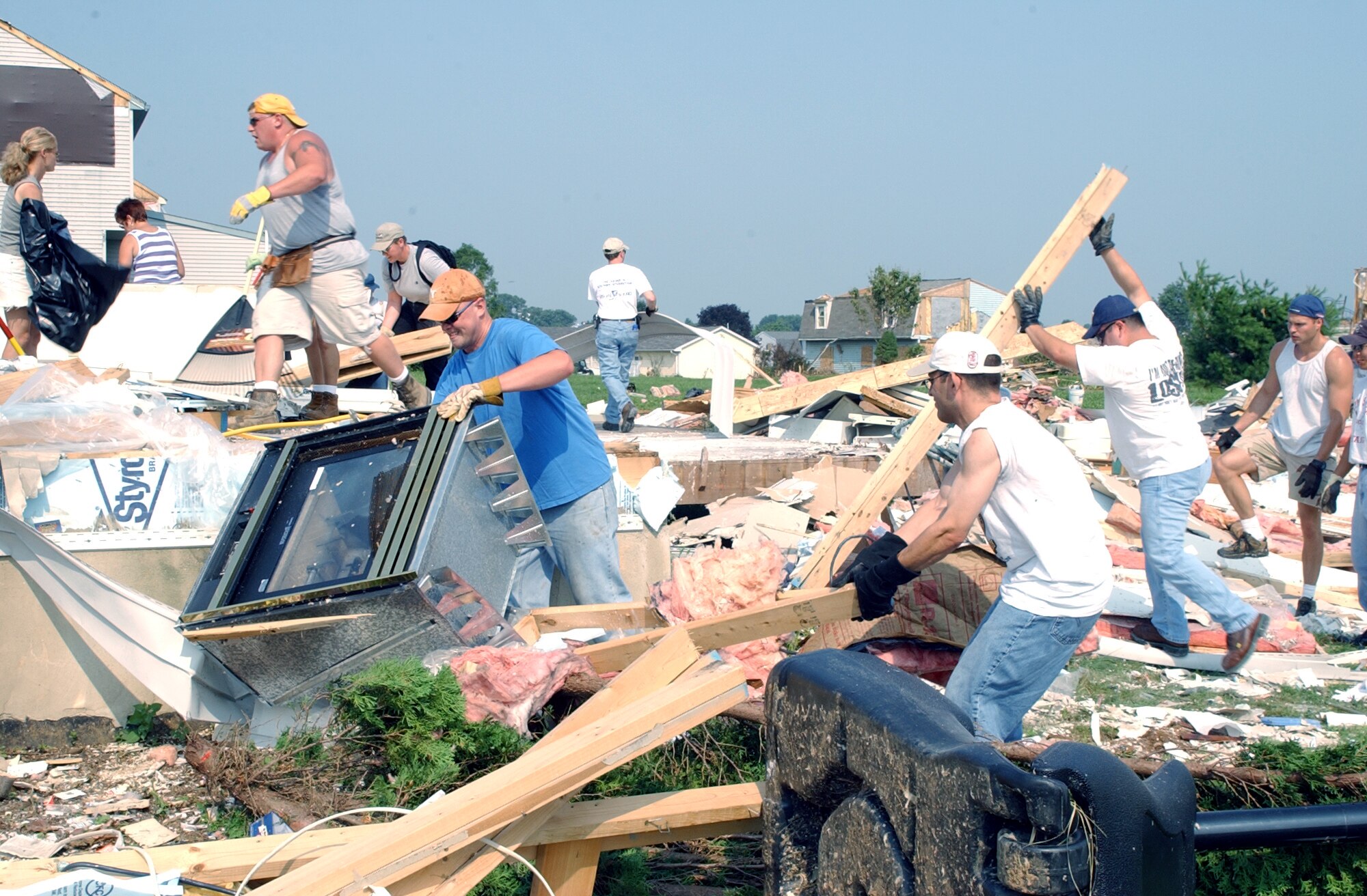 CAMPBELLTOWN, Pa. -- Airmen from the 193rd Special Operations Wing at Middletown, Pa., go to work here July 24 clearing rubble and debris from the property of Senior Master Sgt. John Stewart whose home was destroyed by a tornado July 14.  Sergeant Stewart, an information assurance specialist for the wing, said he is blessed to be a part of the Air National Guard family.  (U.S. Air Force photo by Senior Airman Jay Ostrich)