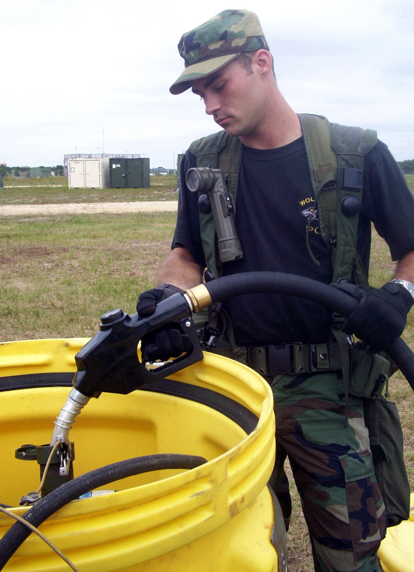 NAVAL AIR AND ENGINEERING STATION LAKEHURST, N.J. -- Senior Airman Roger Robbins fills a 50-gallon fuel bladder with diesel fuel to heat field showers during an Eagle Flag exercise here July 25.  Airman Robbins is a fuels specialist from the 52nd Logistics Readiness Squadron at Spangdahlem Air Base, Germany.  (U.S. Air Force photo by Capt. Phillip Ulmer)