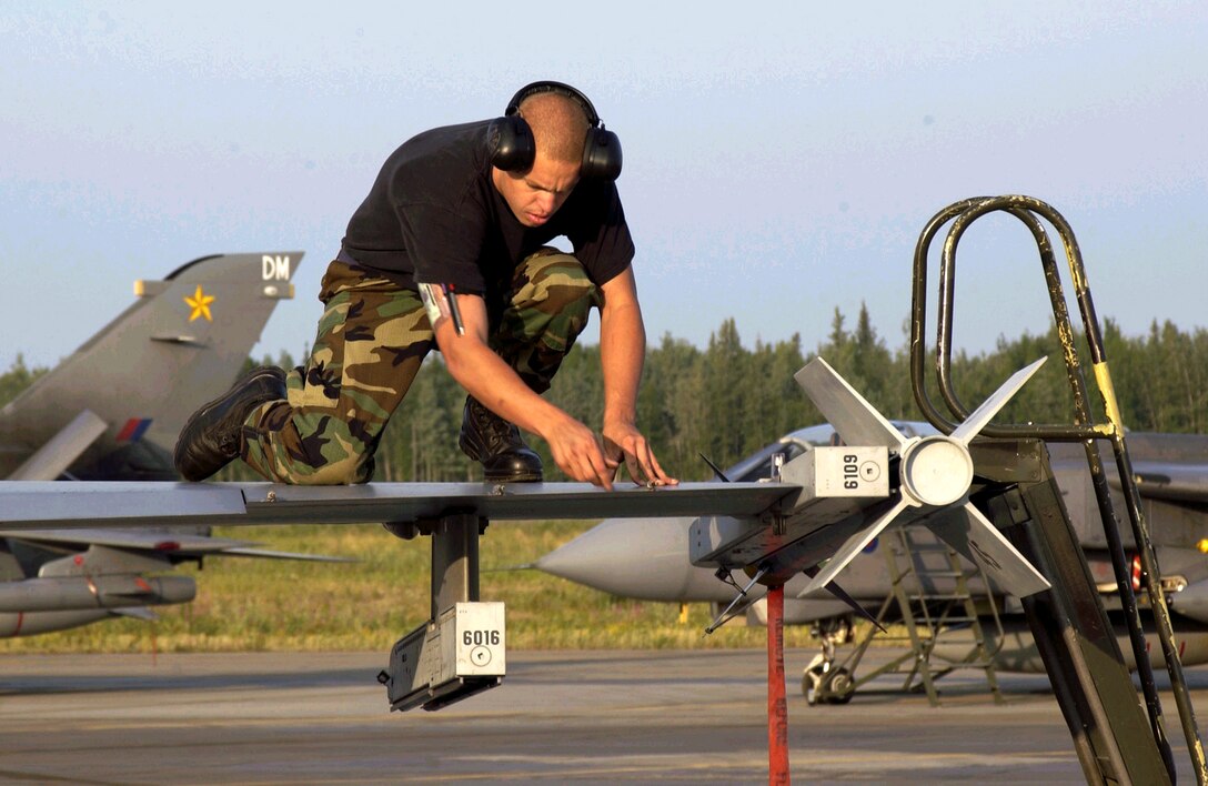 EIELSON AIR FORCE BASE, Alaska -- Senior Airman Jason Ernst inspects a wing tip  of an F-16 Fighting Falcon before a mission supporting operation Cooperative Cope Thunder on July 12. Airman Ernst is a crew chief with the California Air National Guard's 144th Fighter Wing in Fresno. (U.S. Air Force photo by Senior Mast Sgt. Chris Drudge)