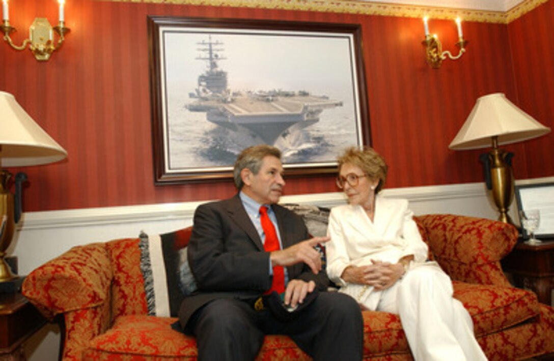 Deputy Secretary of Defense Paul Wolfowitz talks with Nancy Reagan in the captain's cabin of the USS Ronald Reagan on July 23, 2004. Wolfowitz and Reagan are aboard the aircraft carrier for its homeport ceremony at Naval Air Station North Island in San Diego, Calif. 
