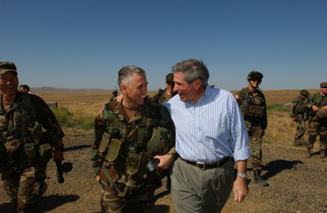 Deputy Secretary of Defense Paul Wolfowitz and Col. Rick Thomas bid each other farewell at the Yakima Training Center in Yakima, Wash., on July 24, 2004. Wolfowitz traveled to Yakima to observe military exercises. Thomas is a commander with the 1st Special Forces Group in Fort Lewis, Wash. 