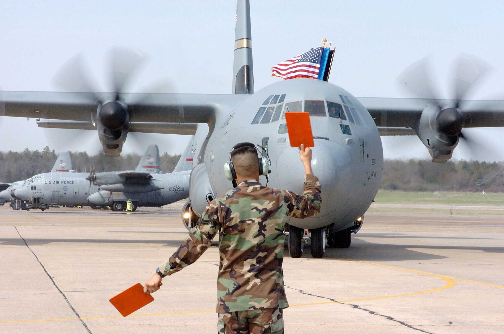 LITTLE ROCK AIR FORCE BASE, Ark. (AFPN) -- Airman 1st Class Antonio Perez marshals in the first active-duty C-130J Hercules here March 19.  Air Force officials are standing by the aircraft despite a recent Department of Defense inspector general report criticizing the program. (U.S. Air Force photo by Tech. Chris Steffen)