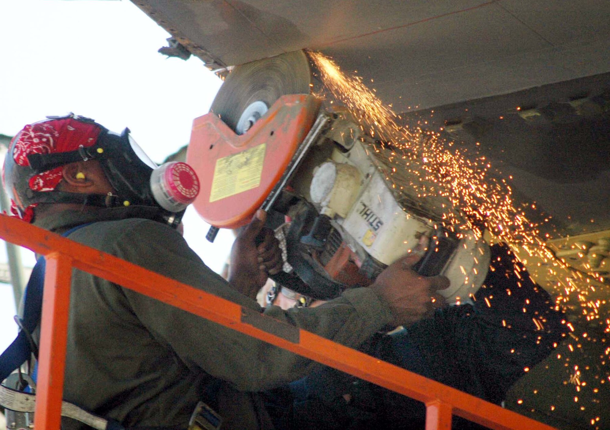 ROBINS AIR FORCE BASE, Ga. (AFPN) -- Senior Airman Aaron Cooper saws through the wing of a C-5A Galaxy as part of an engineering structural analysis project.  Airman Cooper is assigned to the base's 653rd Combat Logistics Support Squadron.  (U.S. Air Force photo by Sue Sapp)