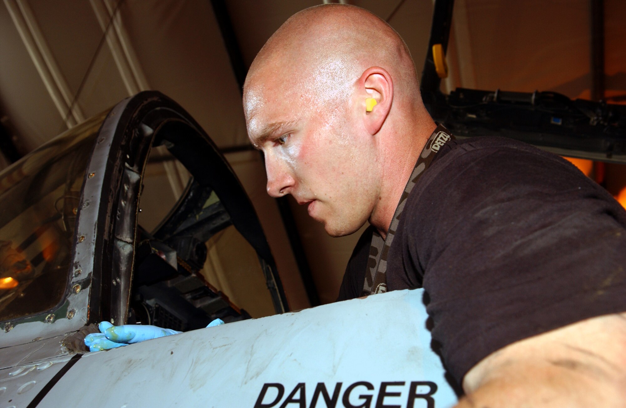 BAGRAM AIR BASE, Afghanistan -- Staff Sgt. Bruce Ginkel applies sealant to an A-10 Thunderbolt II canopy during phase maintenance.  The sealant helps maintain cockpit pressurization.  Each A-10 here is taken apart after 400 flying hours so maintainers can perform preventative maintenance.  Sergeant Ginkel is assigned to the 355th Expeditionary Aircraft Maintenance Squadron here.  (U.S. Air Force photo by Master Sgt. Andrew Gates)