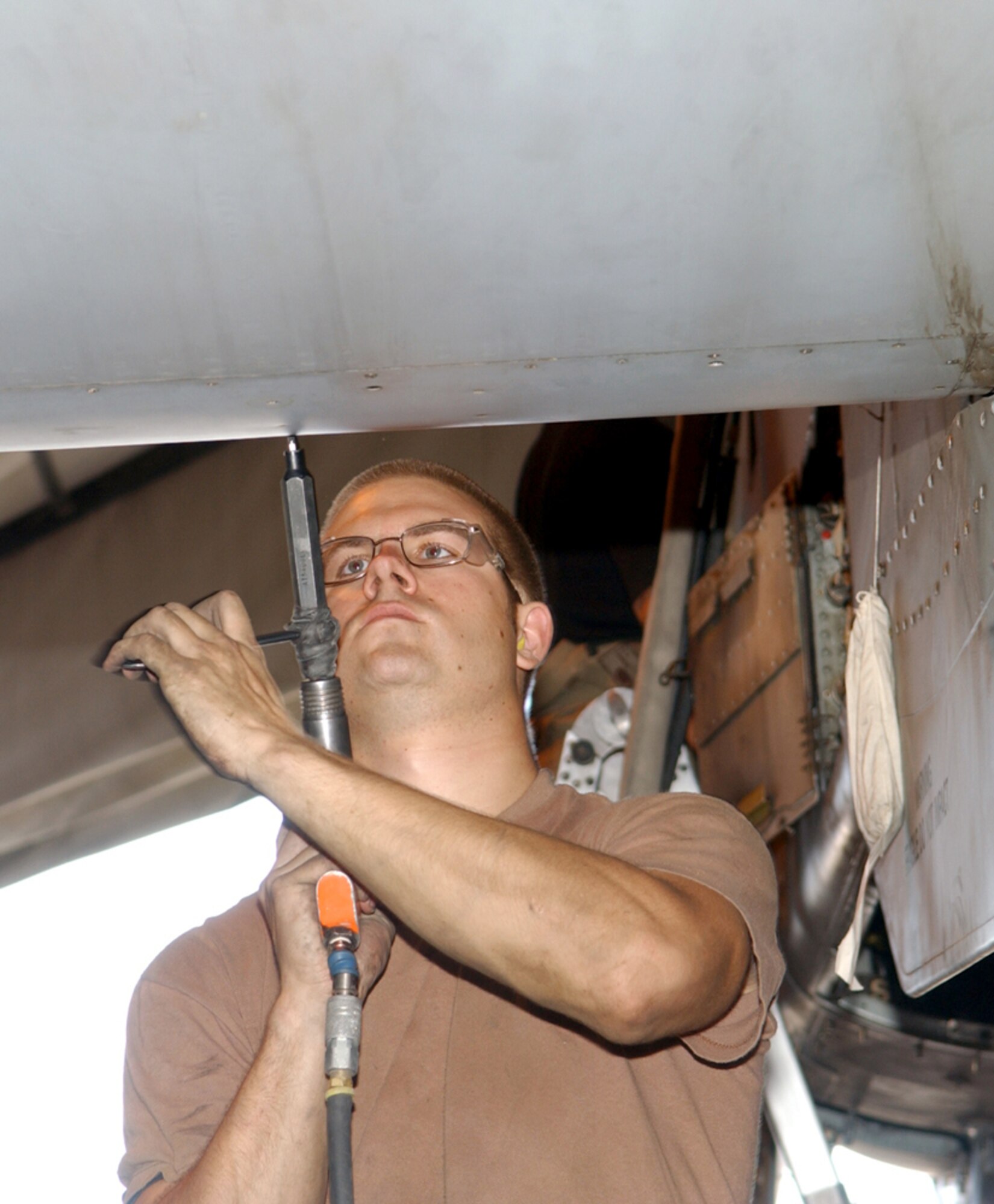 BAGRAM AIR BASE, Afghanistan -- Airman 1st Class Nicholas Burris removes slat panels from an A-10 Thunderbolt II wing.  Each A-10 here is taken apart after 400 flying hours so maintainers can perform preventative maintenance.  Airman Burris is assigned to the 355th Expeditionary Aircraft Maintenance Squadron here.  (U.S. Air Force photo by Master Sgt. Andrew Gates)