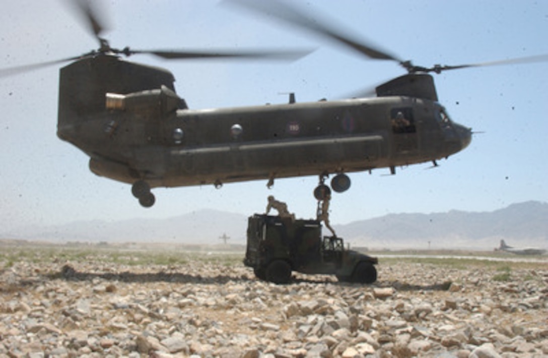 U.S. Army soldiers prepare a Humvee to be sling-loaded by a CH-47 Chinook helicopter in Bagram, Afghanistan, on July 24, 2004. The soldiers are with the 25th Infantry Division. 