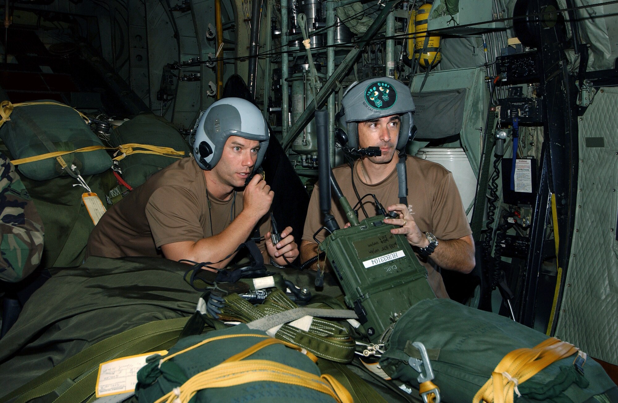OVER THE ATLANTIC OCEAN (AFPN) - Pararescuemen from the 38th Rescue Squadron at Moody Air Force Base, Ga., go over their mission plans as they are flown 350 miles northeast of the Caribbean island of St. Maarten to provide medical support to a Chinese fisherman July 23.  The fisherman sustained a life-threatening chest injury the day before.  After parachuting out of a U.S. Air Force HC-130 aircraft, the pararescuemen reached the fishing vessel and helped the man.  (U.S. Air Force photo by Airman 1st Class Joshua T. Jasper)