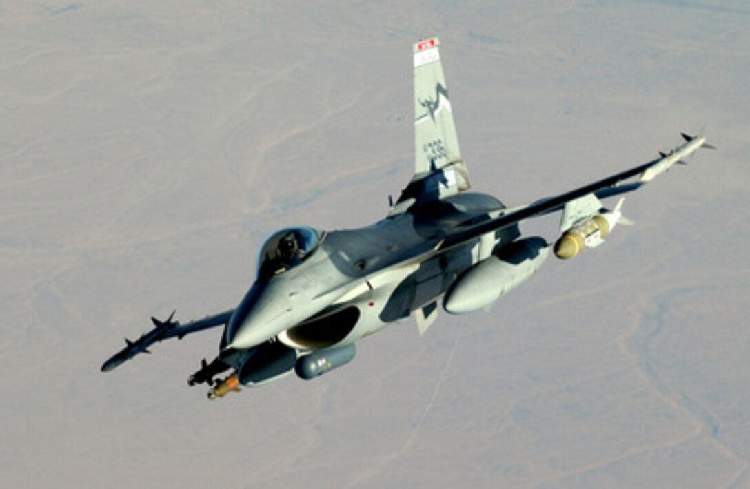 A U.S. Air Force F-16 Fighting Falcon flies through the sky during a combat mission over Iraq on July 23, 2004. 