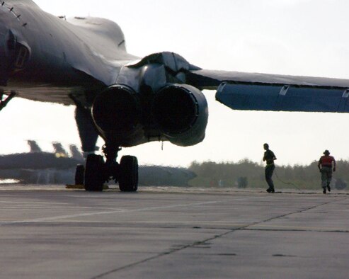 Crew chiefs prepare a B-1B Lancer for takeoff after the aircrew boarded and started the engines on an island in the British Indian Ocean Territory, July 30, 2004. After Sept. 11, 2001, B-1Bs and B-52s deployed to the area to strike targets within Afghanistan.  (U.S. Air Force photo by Master Sgt. Sean Brennan)