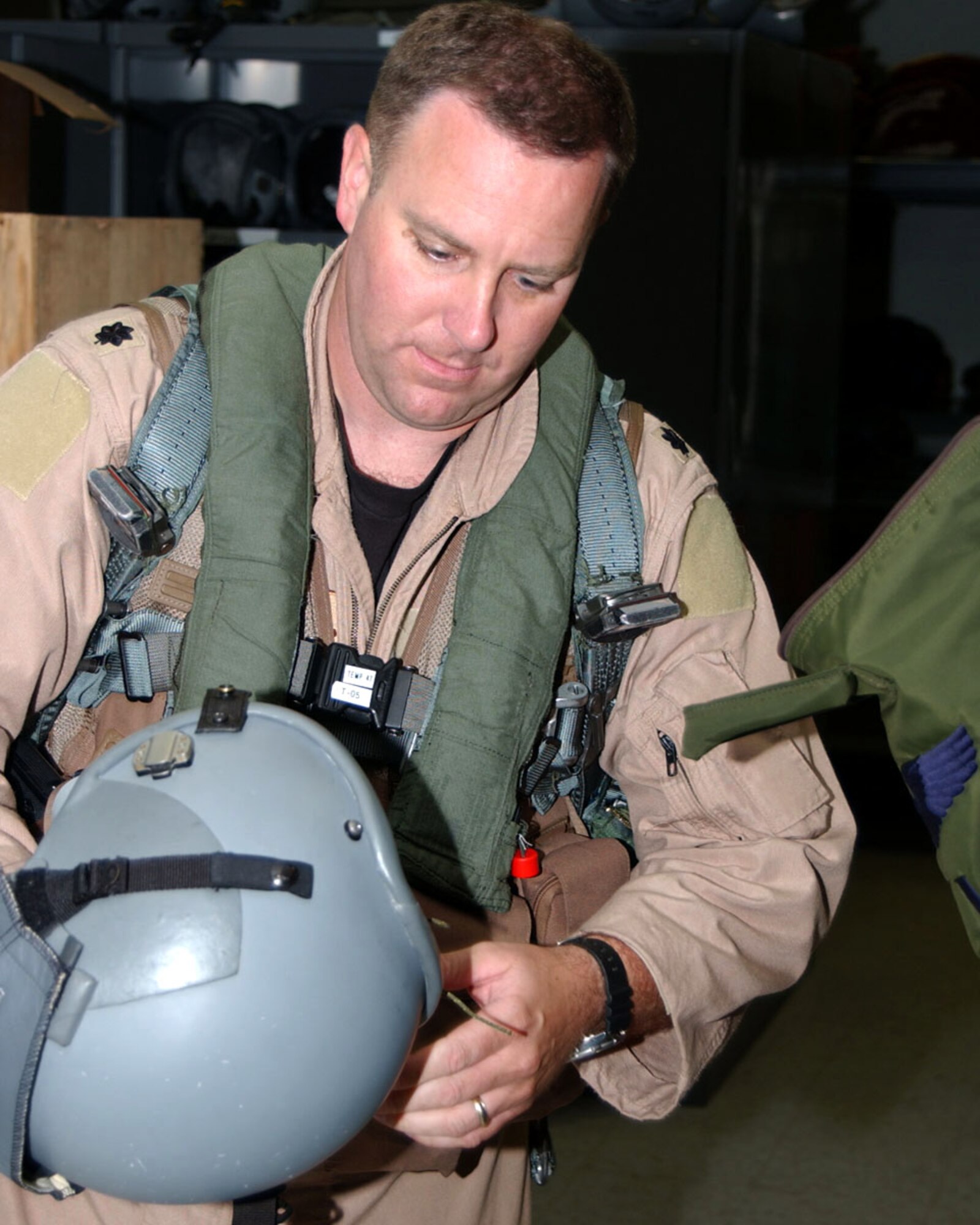 OPERATION ENDURING FREEDOM -- Lt. Col. Dave Garrett inspects his life-support equipment before heading to his aircraft to begin a mission.  Colonel Garrett is a B-1 Lancer pilot and assistant director of operations for 37th Expeditionary Bomb Squadron.  (U.S. Air Force photo by Master Sgt. Sean Brennan)