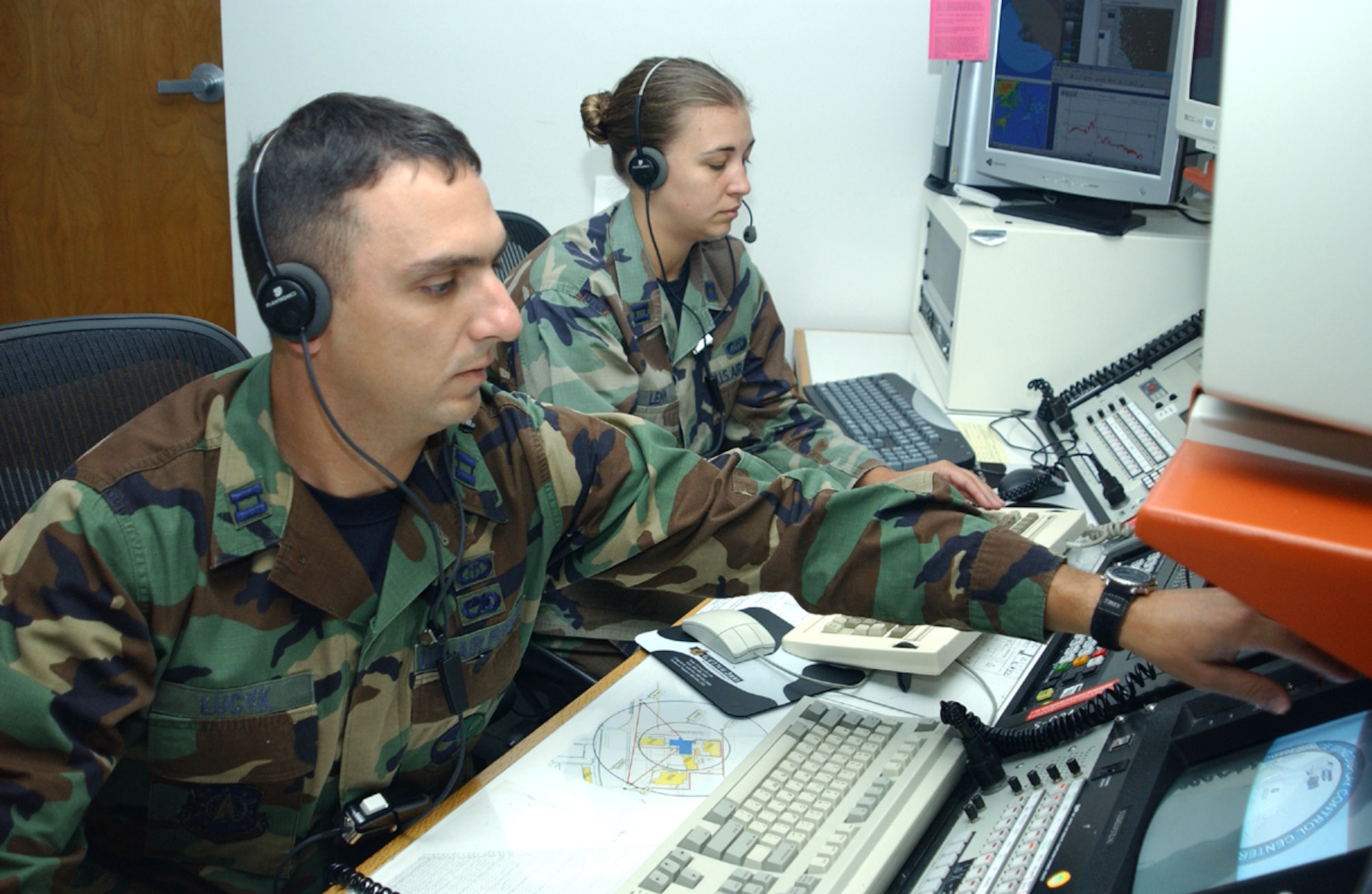 VANDENBERG AIR FORCE BASE, Calif.  --Capts. Paul Lucyk (left) and Breea Lemm perform simulated duties while preparing for upcoming missile or rocket launches here.  Both captains are assigned to the 30th Weather Squadron.  (U.S. Air Force photo by Airman 1st Class Matthew Reed)