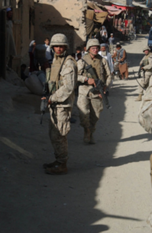 Army National Guard soldiers and Marines conduct foot patrols on the streets of Ghazni, Afghanistan, on July 26, 2004. The soldiers are assigned to 3rd Battalion, 116th Infantry and the Marines are from India Company, 3rd Battalion, 6th Marines. Both are deployed to Afghanistan in support of Operation Enduring Freedom. 