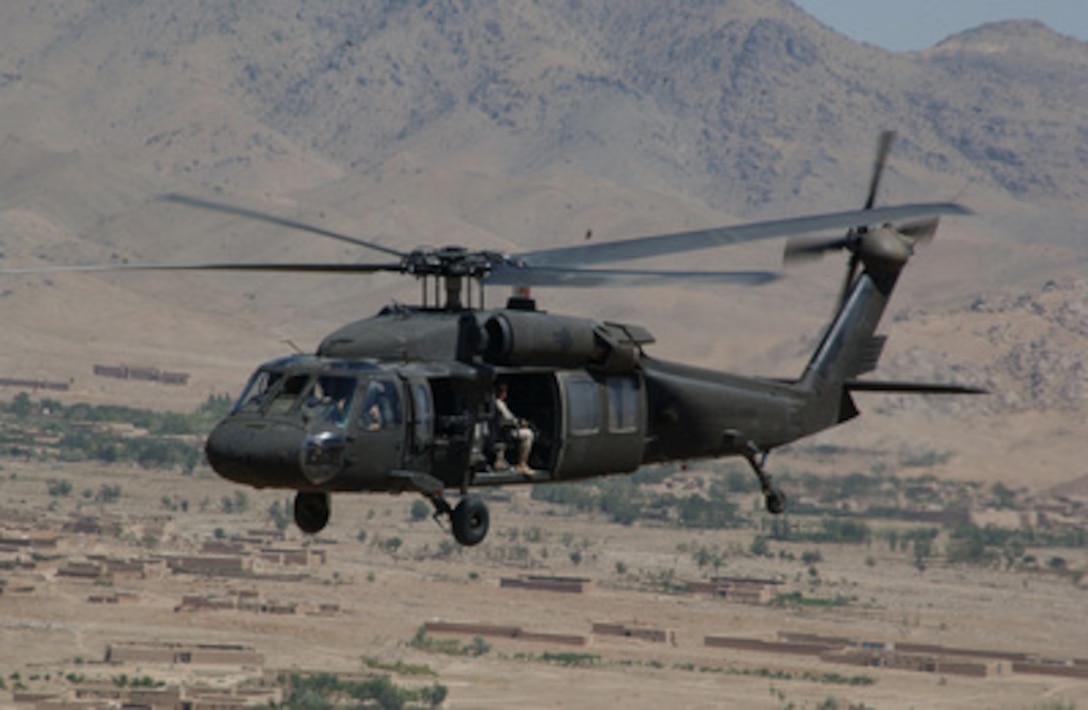 An Army UH-60 Black Hawk helicopter transports soldiers from Bagram Airfield over Ghazni, Afghanistan, on July 26, 2004. The soldiers are assigned to the 25th Infantry Division and deployed in support of Operation Enduring Freedom. 