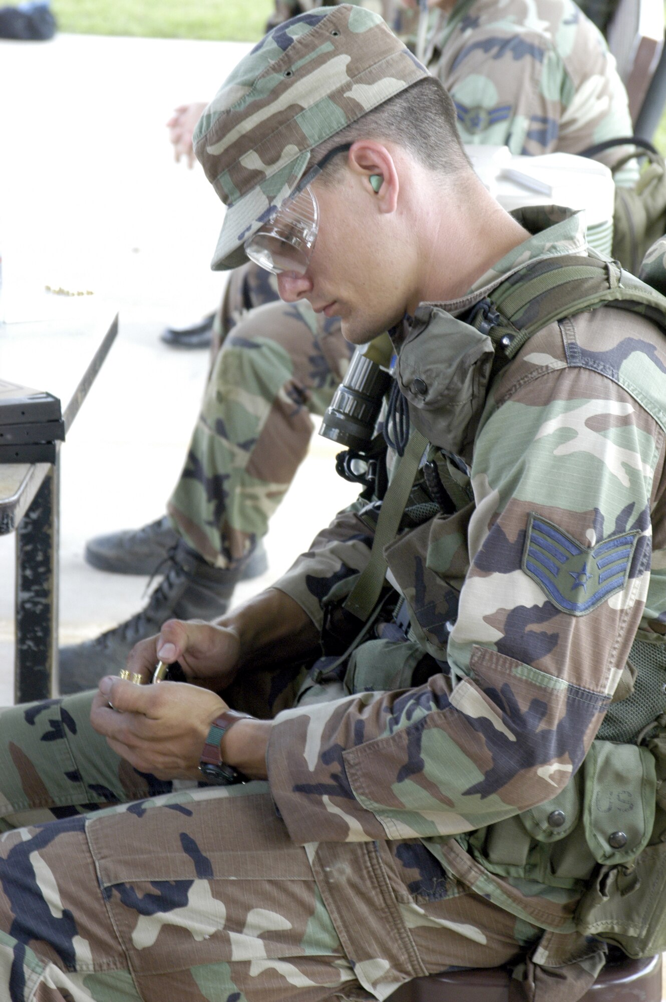 LACKLAND AIR FORCE BASE, Texas -- Staff Sgt. Jack Gilbert unloads a magazine following weapons practice during the Air Education and Training Command Combat Weapons and Tactics Course here.  He is a combat arms instructor with the 342nd Training Squadron.  (U.S. Air Force photo by Wayne Bryant)