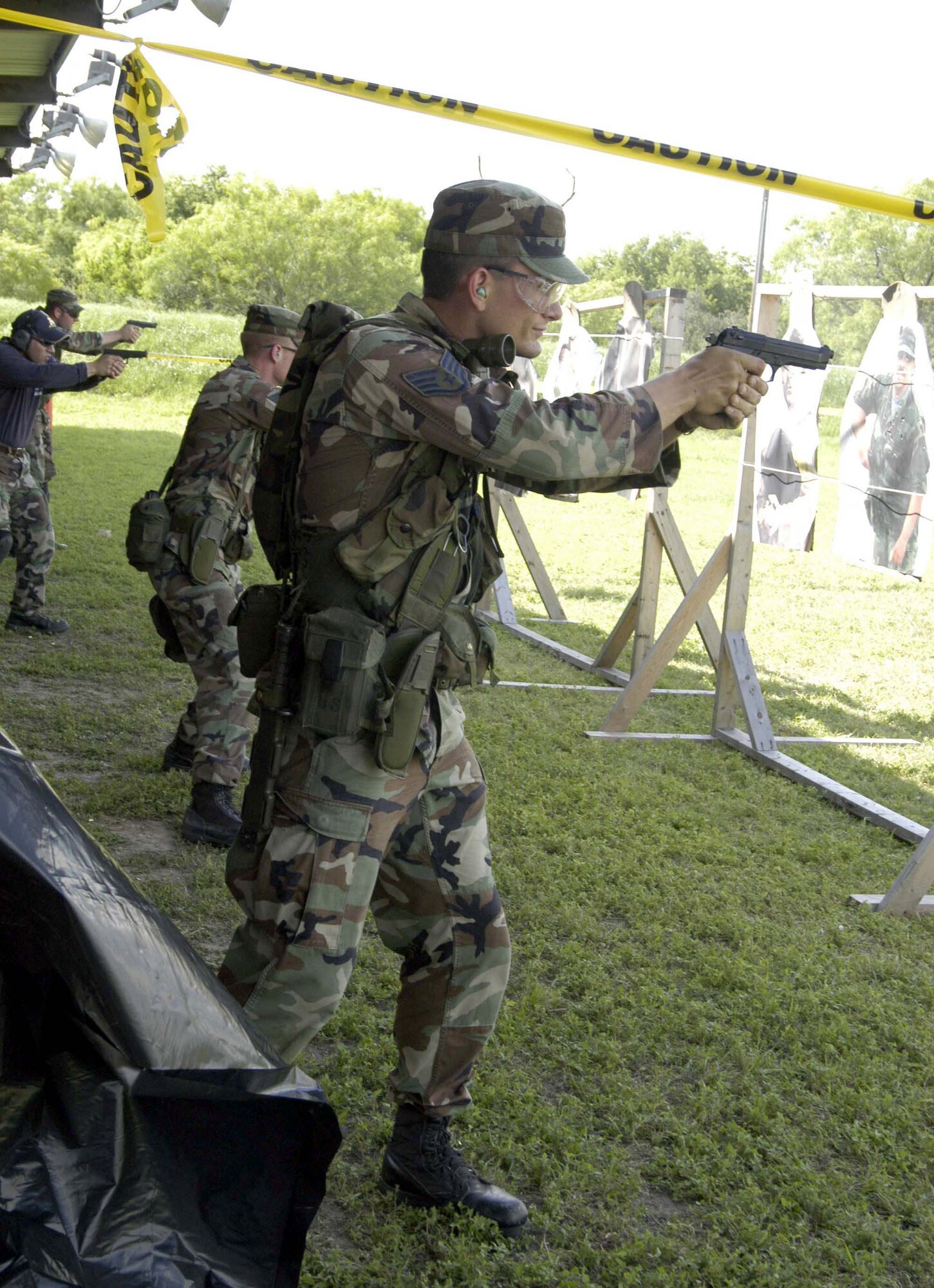 LACKLAND AIR FORCE BASE, Texas -- Staff Sgt. Jack Gilbert fires his 9 mm pistol at a practice session during the Air Education and Training Command Combat Weapons and Tactics Course here.  He is a combat arms instructor with the 342nd Training Squadron.  (U.S. Air Force photo by Wayne Bryant)