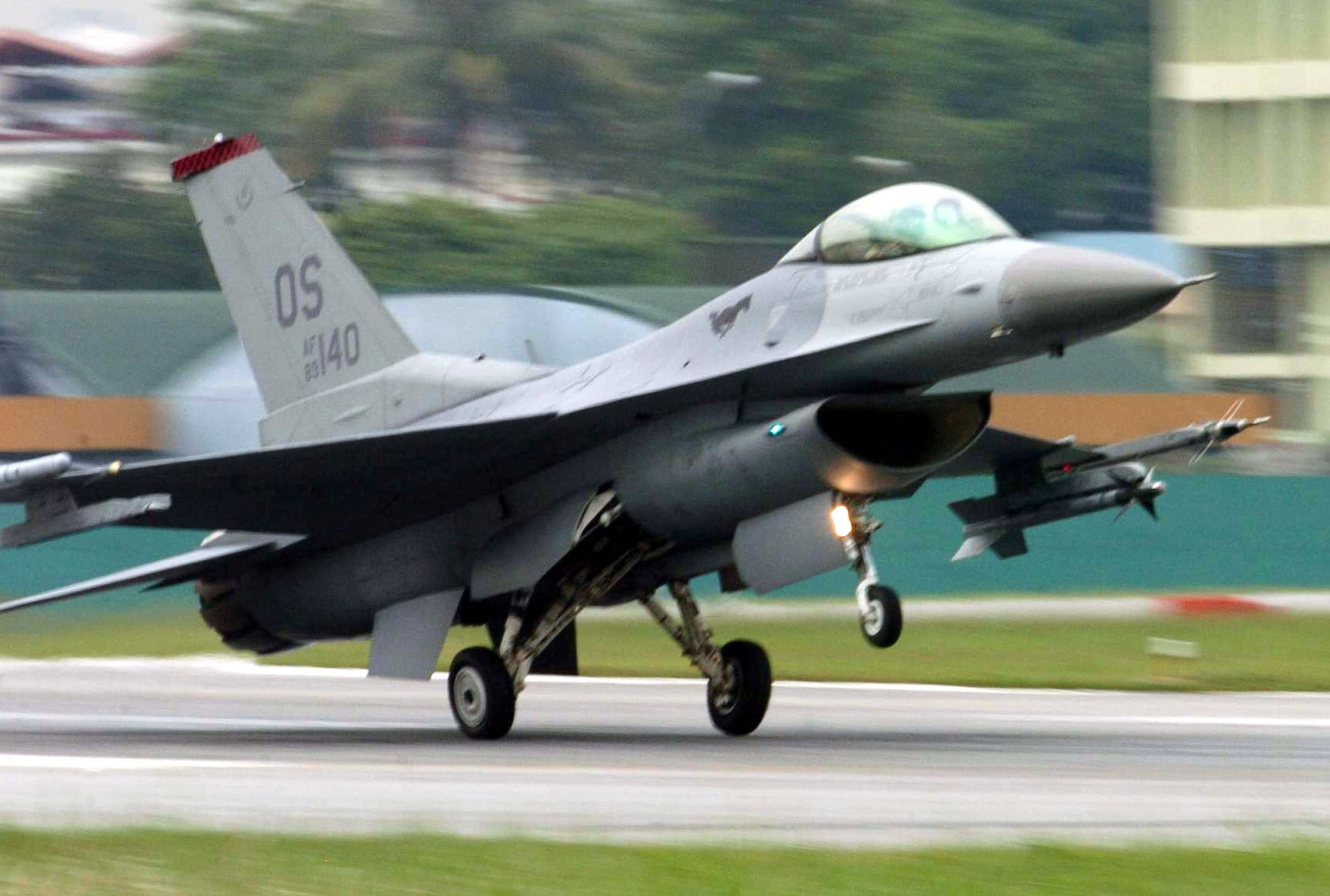 PAYA LEBAR AIR BASE, Singapore -- An F-16 Fighting Falcon from the 36th Fighter Squadron at Osan Air Base, South Korea, lands here after a mission during Commando Sling 04-3.  U.S. and Singaporean Airmen trained together using realistic dissimilar aircraft air-to-air combat tactics.  (U.S. Air Force photo by Master Sgt. Val Gempis)