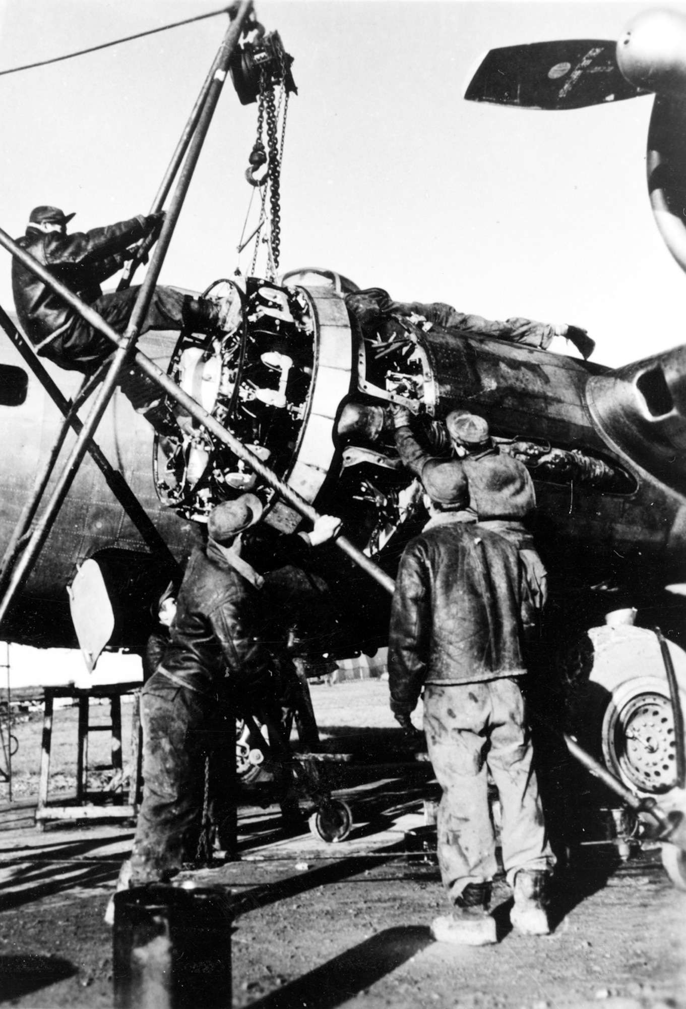 NUTHAMPSTEAD, England -- Aircraft mechanics with the 398th Bombardment Group change a B-17 Flying Fortress engine here.  During the group's stay in England from May 1944 to April 1945, the 398th flew 195 missions and lost 292 men and 70 B-17 aircraft in combat.  (Courtesy photo)