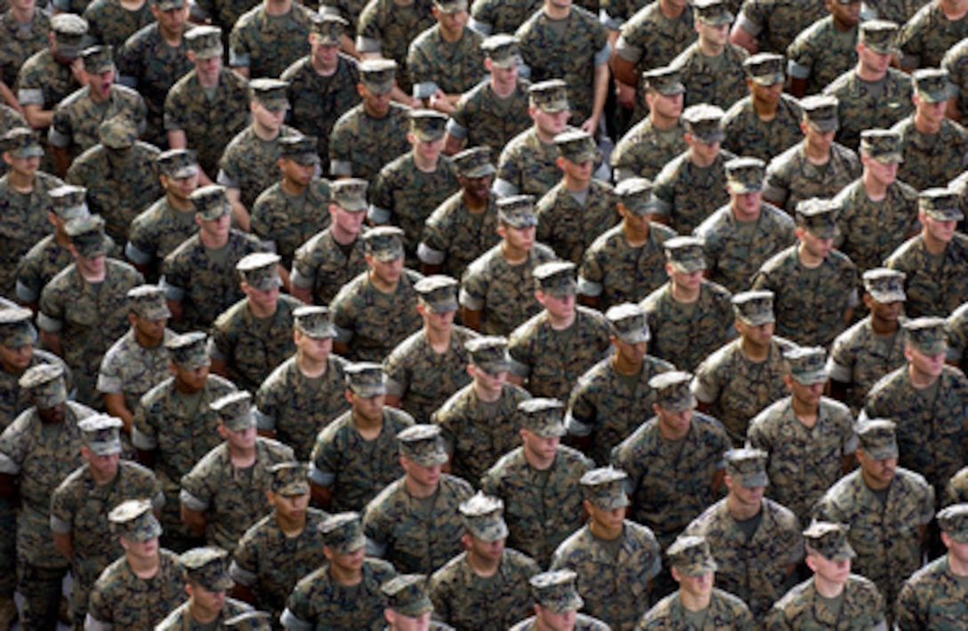 A formation of U.S. Marines listens to Secretary of Defense Donald H. Rumsfeld as he talks to sailors and Marines of the USS Essex (LHD 2) while in port at Changi Naval Base, Singapore, on June 4, 2004. Rumsfeld is in Singapore to attend the International Institute for Strategic Studies Conference. 