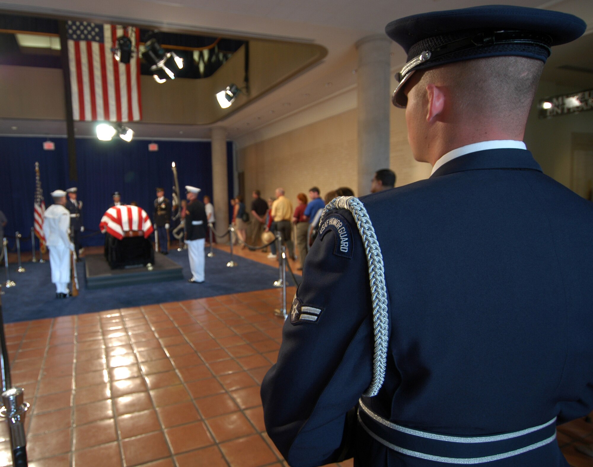 SIMI VALLEY, Calif. -- An Airman assigned to the U.S. Air Force Honor Guard at Bolling Air Force Base, D.C., stands watch as people pay their respects to former President Ronald Reagan at the Ronald Reagan Presidential Library here.  A state funeral takes place June 11 for President Reagan who died June 5.  (U.S. Navy photo by Petty Officer 1st Class Jon D. Gesch)