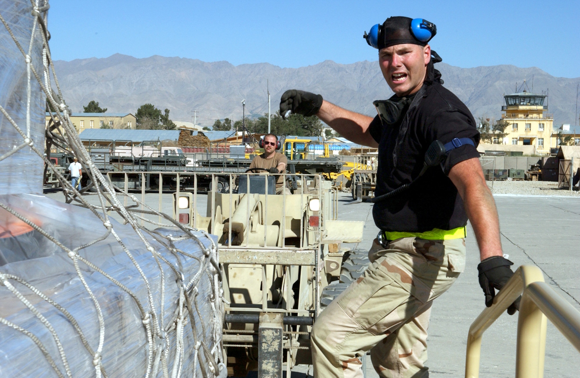 BAGRAM AIR BASE, Afghanistan -- Senior Airman Mike Byerwalters (right) directs Tech. Sgt. Ray Boyea while unloading cargo from a commercial L-10.  The Airmen are assigned to the 455th Expeditionary Logistics Readiness Squadron here and deployed from the 109th Aerial Port Flight at Stratton Air National Guard Base, N.Y.  (U.S. Air Force photo by Master Sgt. Andrew Gates)