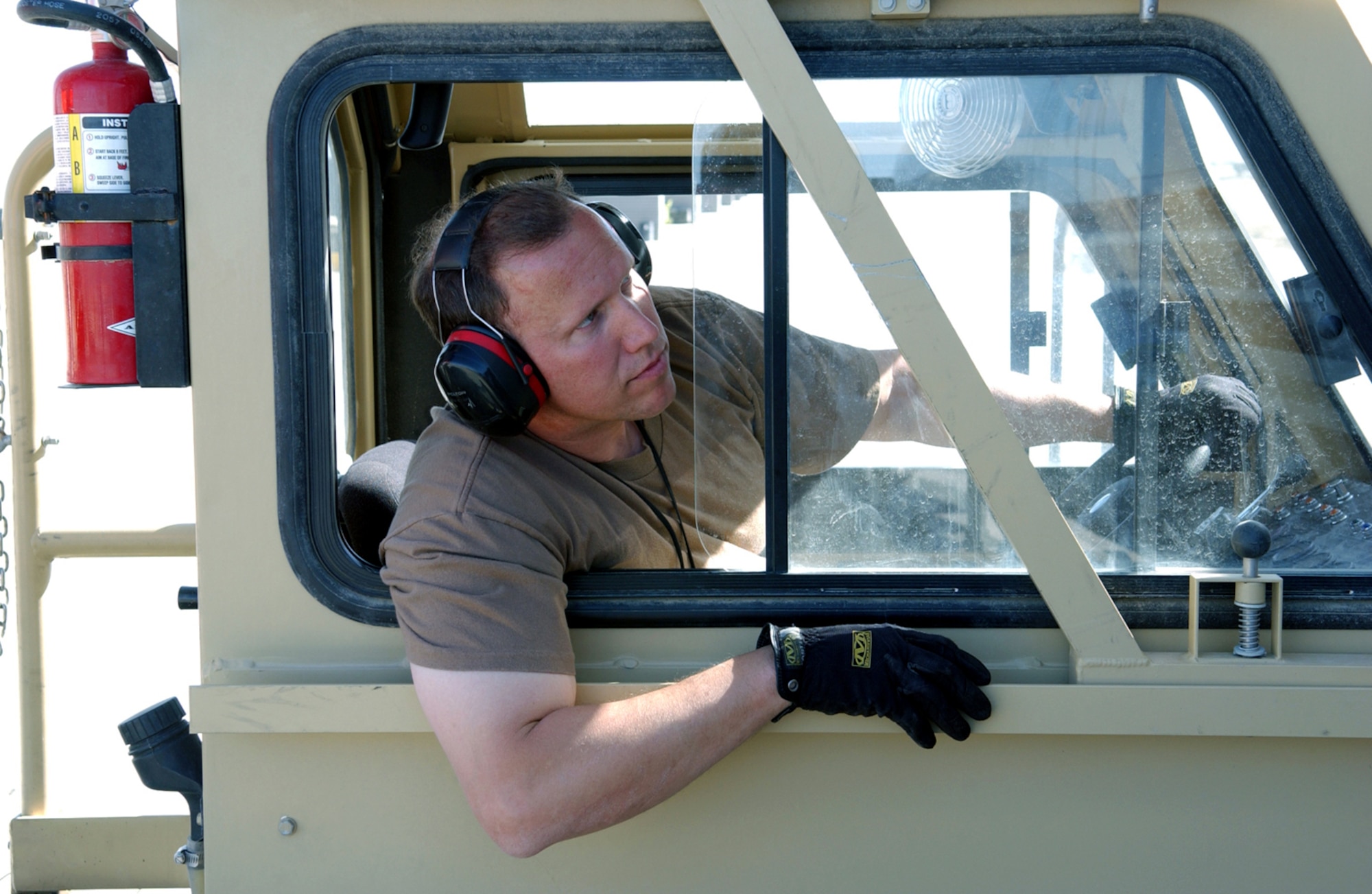 BAGRAM AIR BASE, Afghanistan -- Staff Sgt. John Costello watches for instructions as he drives a new-generation small loader.  The loader can carry up to 25,000 pounds.  Sergeant Costello is assigned to the 455th Expeditionary Logistics Readiness Squadron here.  He is deployed from the 109th Aerial Port Flight at Stratton Air National Guard Base, N.Y.  (U.S. Air Force photo by Master Sgt. Andrew Gates)