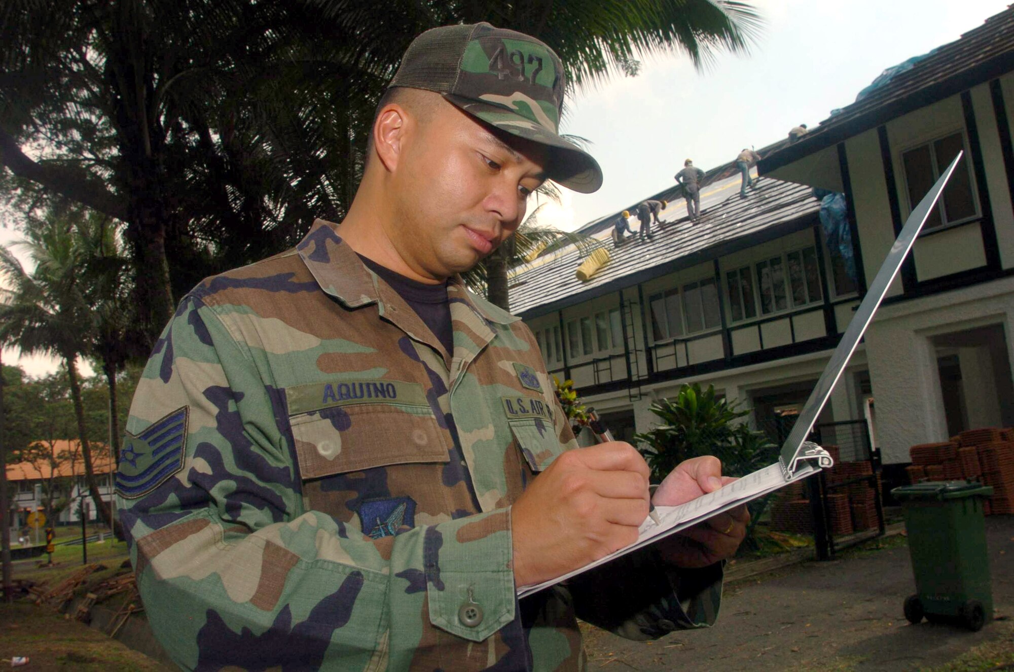 SEMBAWANG, Singapore -- Tech. Sgt. Ricky Aquino inspects the work of local contractors on a house used by Airmen here.  Sergeant Aquino is a civil engineer Airman from the 497th Combat Training Squadron.  The squadron supports regular temporary-duty rotations of U.S. fighter aircraft.  (U.S. Air Force photo by Master Sgt. Val Gempis)