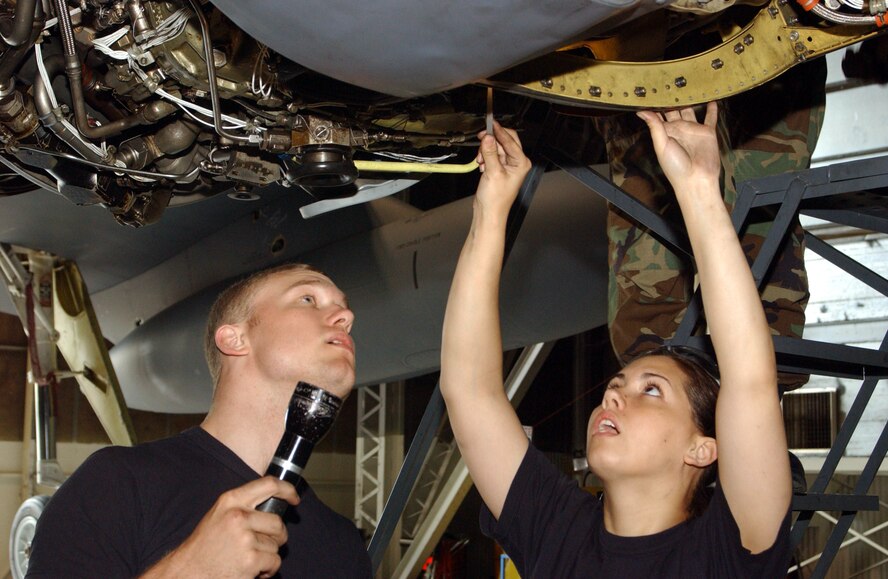MINOT AIR FORCE BASE, N.D -- Airmen 1st Class Mike Eady (left) and Rysta Hupe perform general maintenance on a B-52H Stratofortress engine here June 3.  The Airmen are assigned to the 5th Maintenance Squadron.  (U.S. Air Force photo by Airman Alicia M. Schnerre)