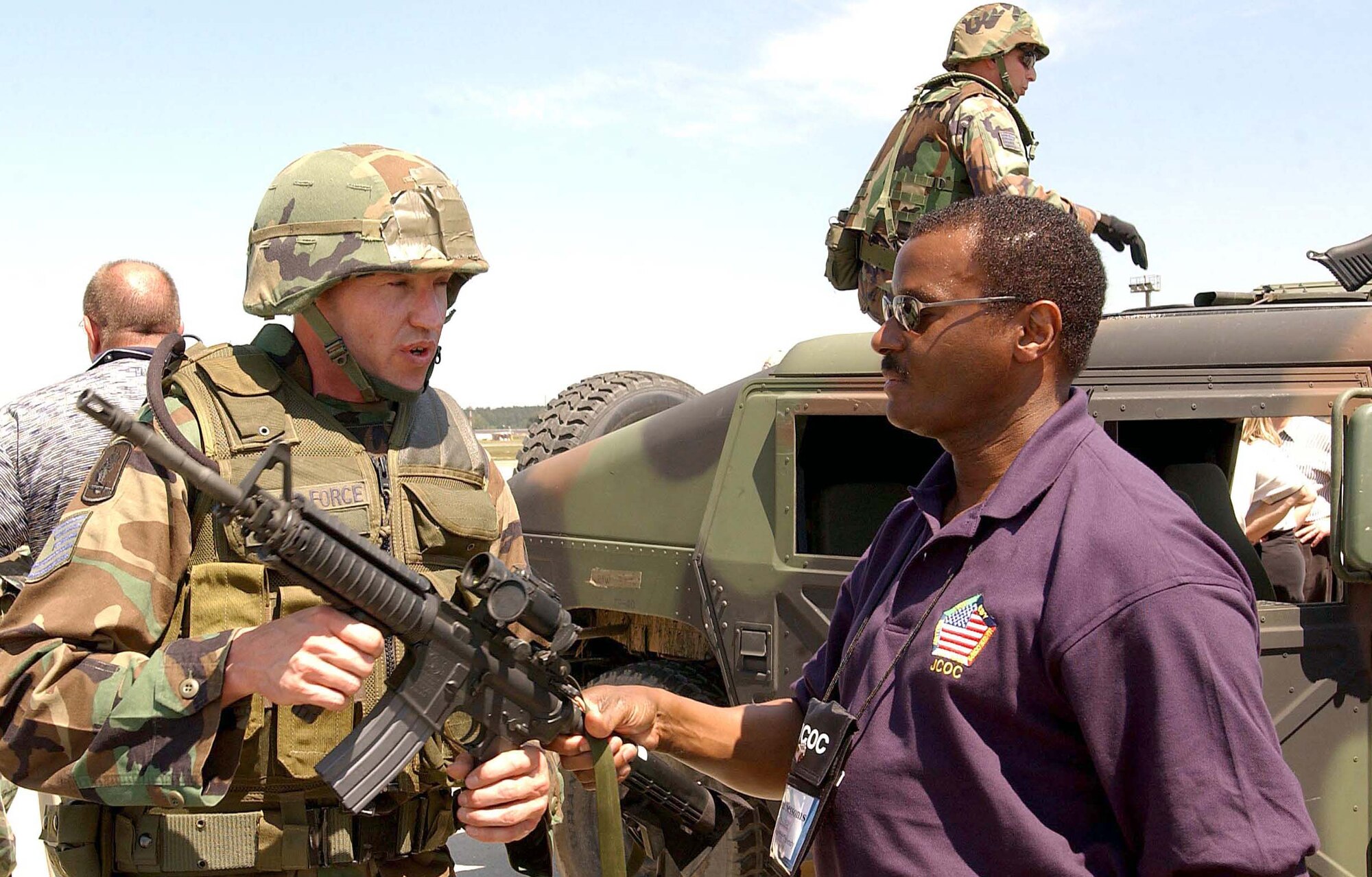 RAMSTEIN AIR BASE, Germany -- Tech. Sgt. Chet Kelly discusses contingency response operations here with Dr. Allen Sessoms.  Dr. Sessoms and other business, academic and local government leaders nationwide participated in the 2004 Joint Civilian Orientation Conference on June 8.  Sergeant Kelly is assigned to the 786th Security Forces Squadron, and Dr. Sessoms is president of Delaware State University.  (U.S. Air Force photo by Tech. Sgt. Michael Buytas)