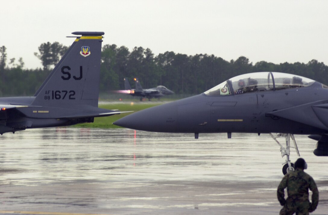 SEYMOUR JOHNSON AIR FORCE BASE, N.C. (AFPN) -- F-15E Strike Eagle pilots from the 4th Fighter Wing here prepare to takeoff for Washington to perform a 21-ship flyover and a missing-man formation tribute for former President Ronald Reagan's funeral procession.  (U.S. Air Force photo by Staff Sgt. Angela Pope)