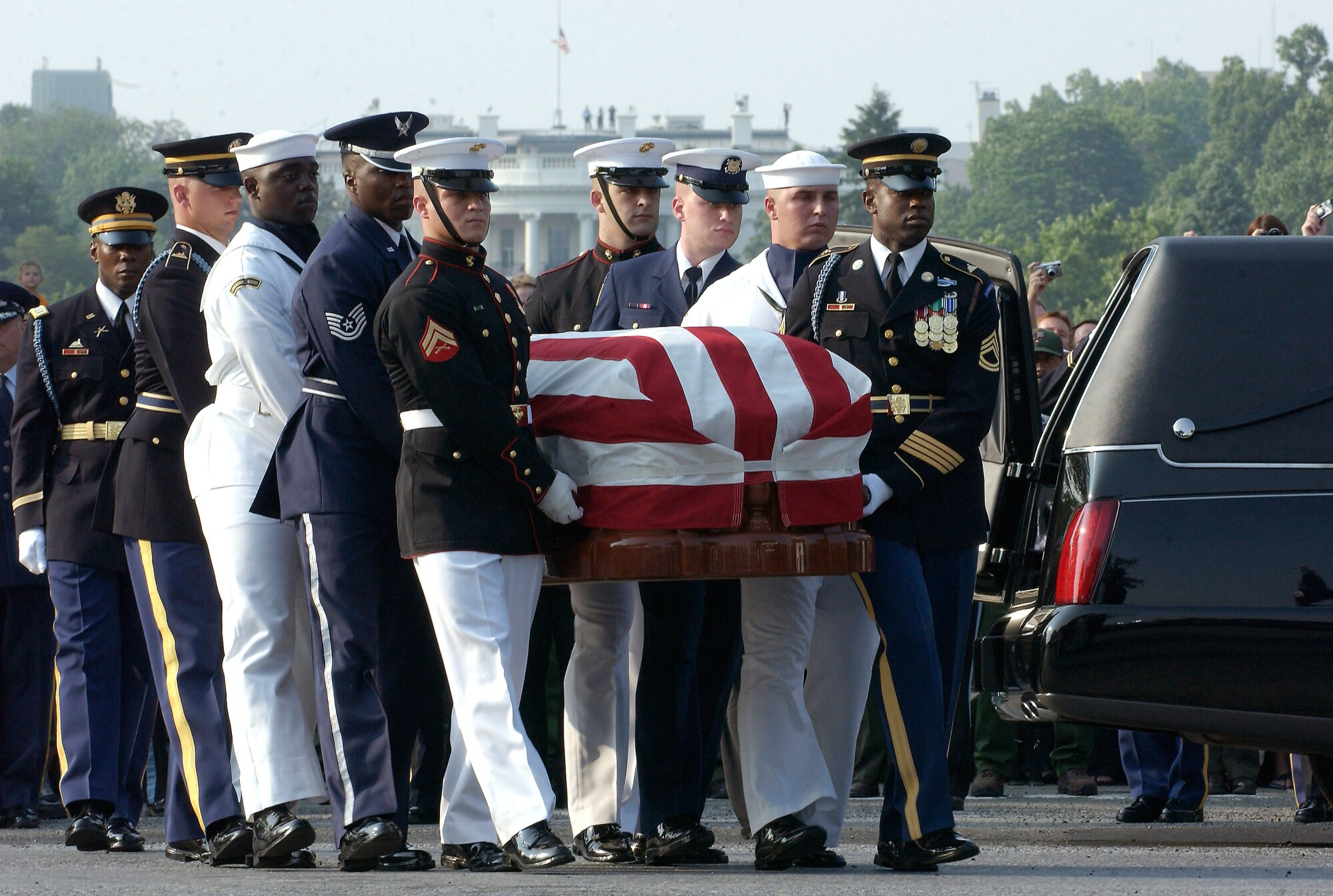 WASHINGTON (AFPN) -- Members of a joint honor guard carry former President Ronald Reagan's flag-draped casket to a horse-drawn caisson for the funeral procession here June 9.  President Reagan will lie in state in the Capitol Rotunda until June 11.  He served as the military's commander-in-chief from 1981 to 1989.  (U.S. Air Force photo by Master Sgt. Jim Varhegyi)