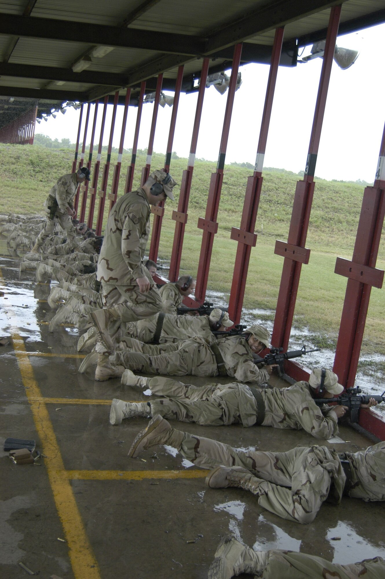 LACKLAND AIR FORCE BASE, Texas -- Staff Sgt. Scott Grant (foreground) and Tech. Sgt. Richard Conrad observe as students begin firing their M-4 carbines during a Basic Combat Convoy Course here.  The 342nd Training Squadron instructors will be working seven days a week, 18 hours a day for 13 weeks as several hundred students go through the course.  (U.S. Air Force photo by James Coburn)