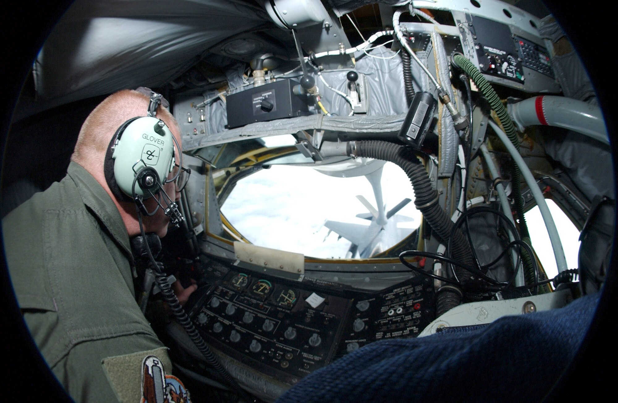 OVER ALASKA -- Senior Master Sgt. Matt Glover watches as an F-16 Fighting Falcon pilot receives fuel from the boom pod of his KC-135 Stratotanker on June 11 during Northern Edge '04.  The exercise is Alaska Command's joint training exercise designed to enhance interoperability among the services.  Sergeant Glover is a boom operator with the Air National Guard's 126th Air Refueling Wing at Scott Air Force Base, Ill.  (U.S. Air Force photo by Senior Airman Joshua Strang)