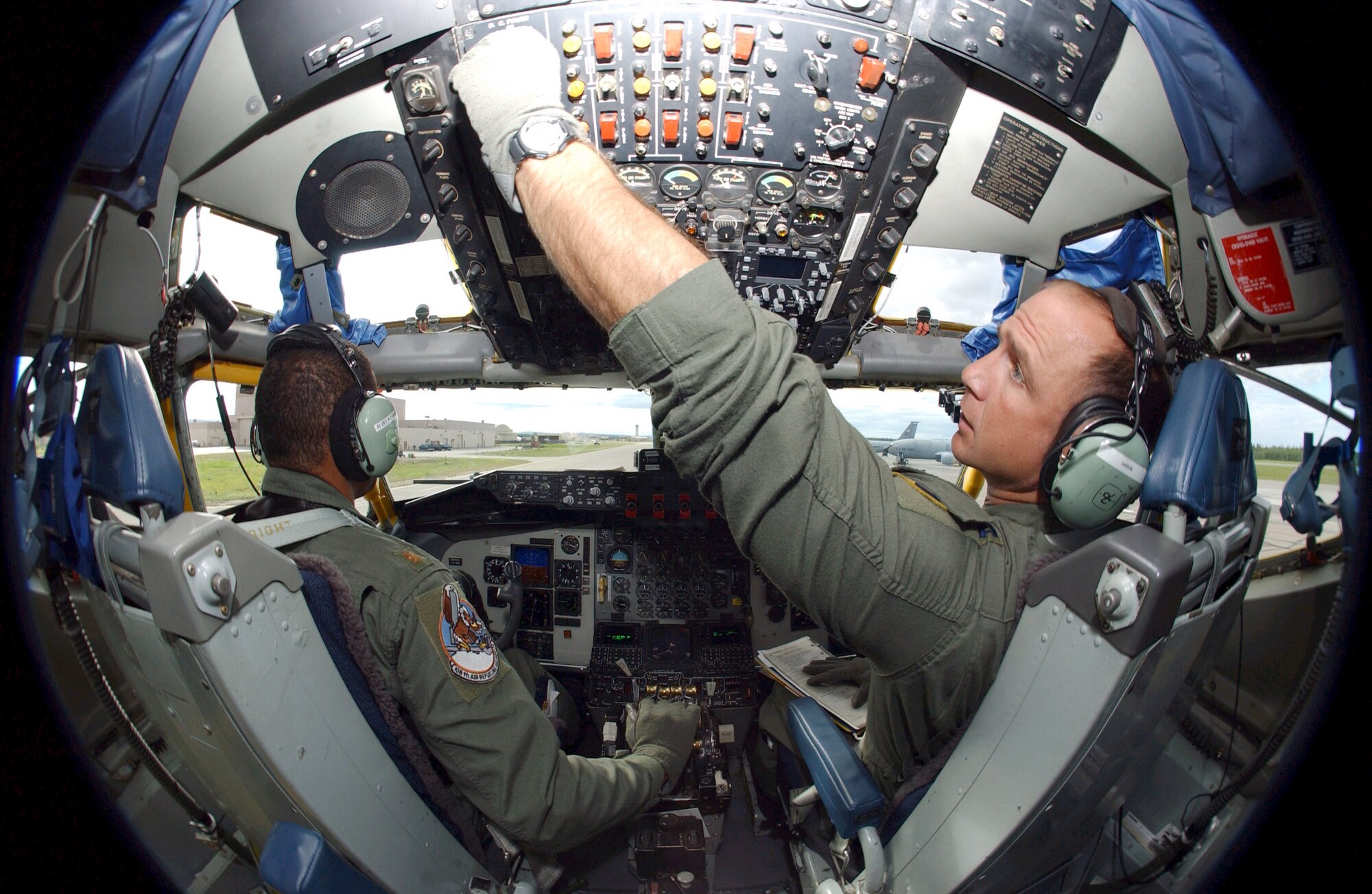EIELSON AIR FORCE BASE, Alaska -- Capt. Nick Babiak (right), co-pilot, checks the controls as Maj. Ralph DeLatour, aircraft commander, taxis a KC-135 Stratotanker on June 11 during Northern Edge '04.  The exercise is Alaska Command's joint training exercise designed to enhance interoperability among the services.  (U.S. Air Force photo by Senior Airman Joshua Strang)