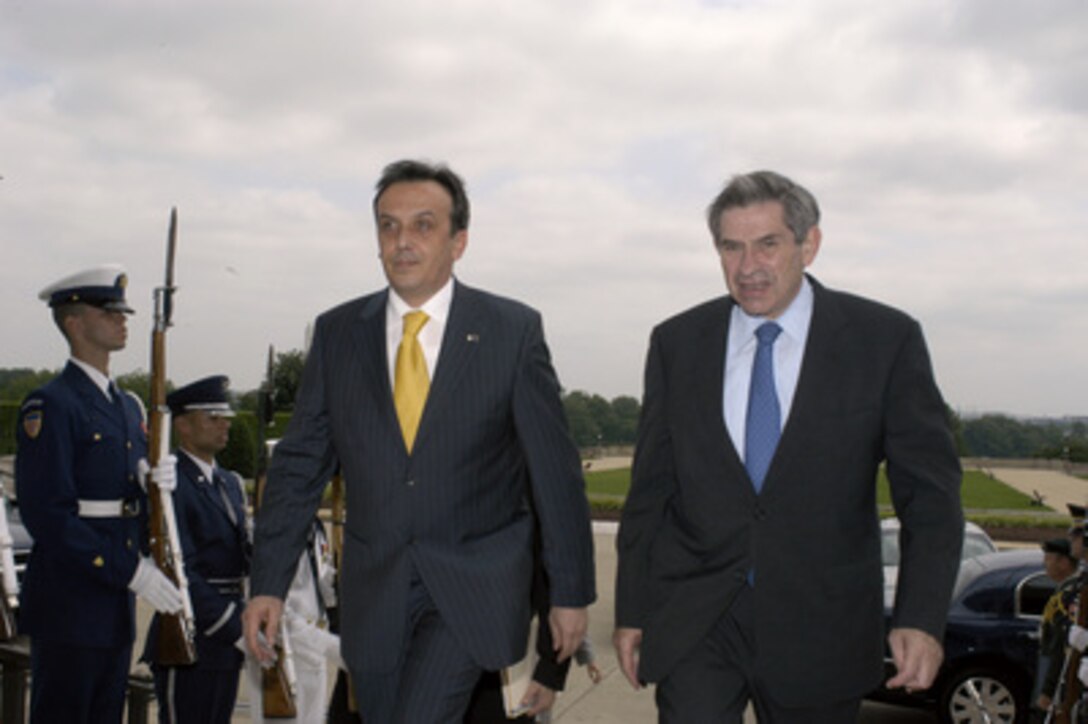 Chairman of the Council of Ministers of Bosnia and Herzegovina Adnan Terzic (left) is escorted into the Pentagon by Deputy Secretary of Defense Paul Wolfowitz (right) on June 14, 2004. The two leaders are meeting to discuss defense issues of mutual interest. 