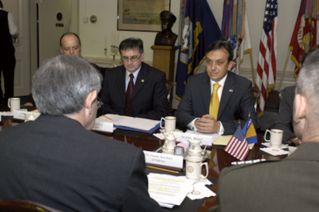 Chairman of the Council of Ministers of Bosnia and Herzegovina Adnan Terzic (right) meets with Deputy Secretary of Defense Paul Wolfowitz (left foreground) on June 14, 2004. Terzic is accompanied by Ambassador of Bosnia and Herzegovina Igor Davidovic (left obscured), and Minister of Defense Nikola Radovanovic (center). The leaders are meeting to discuss defense issues of mutual interest. 