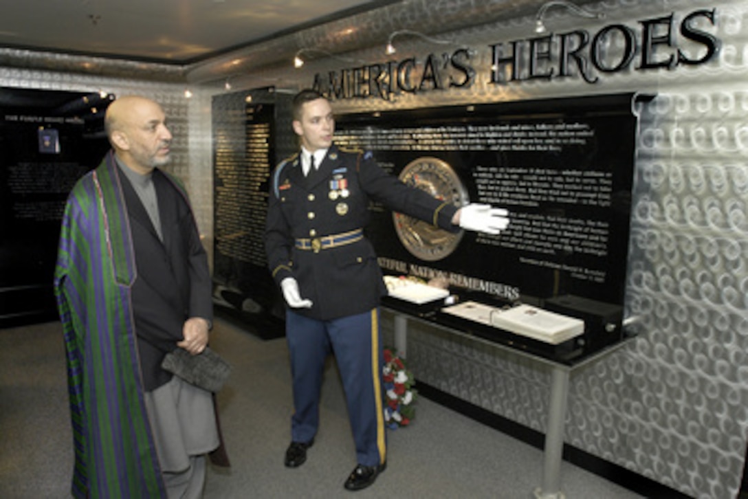 Spec. Kevin Smith, U.S. Army, explains the Pentagon memorial to Afghan President Hamid Karzai during a tour on June 14, 2004. The memorial is dedicated to the 184 persons killed in the terrorists' attack of Sept. 11, 2001. Karzai toured the memorial and the adjacent chapel with Secretary of Defense Donald H. Rumsfeld following their security discussions on June 14, 2004. Smith is a native of Oakland, Calif. 